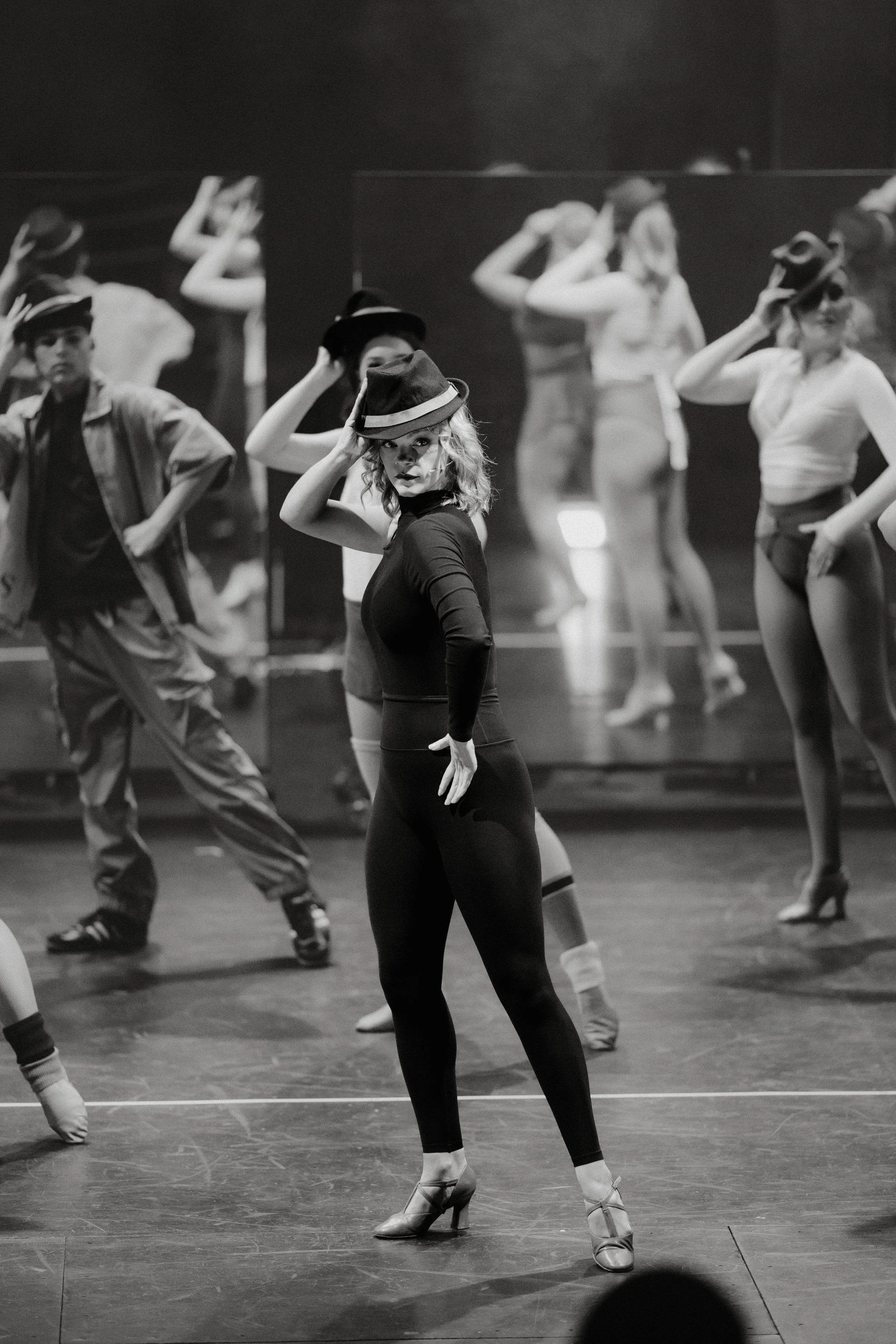 Black and white frame of the cast in top hats during the hat number