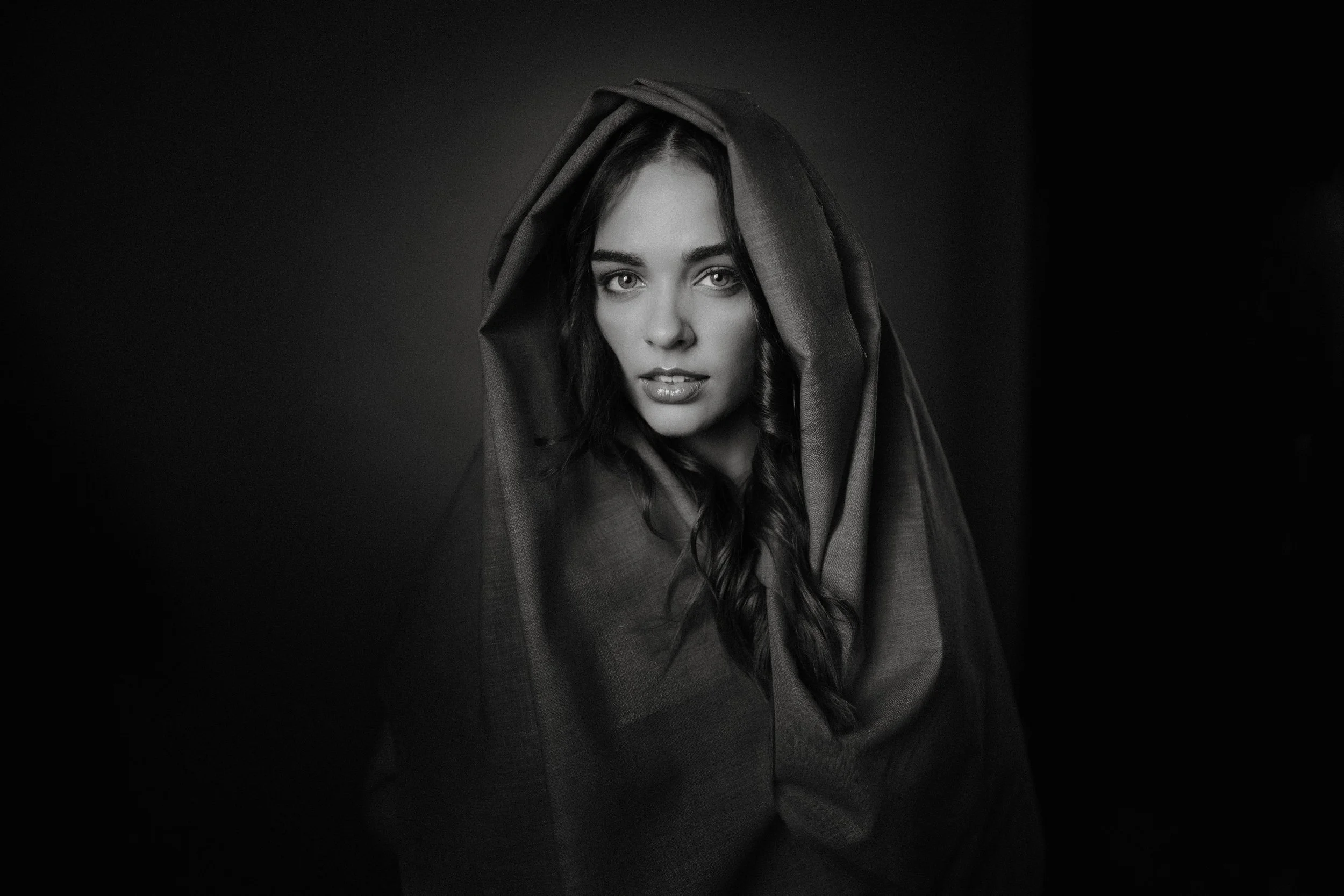 Black and white portrait of Erin Hobden in a hood