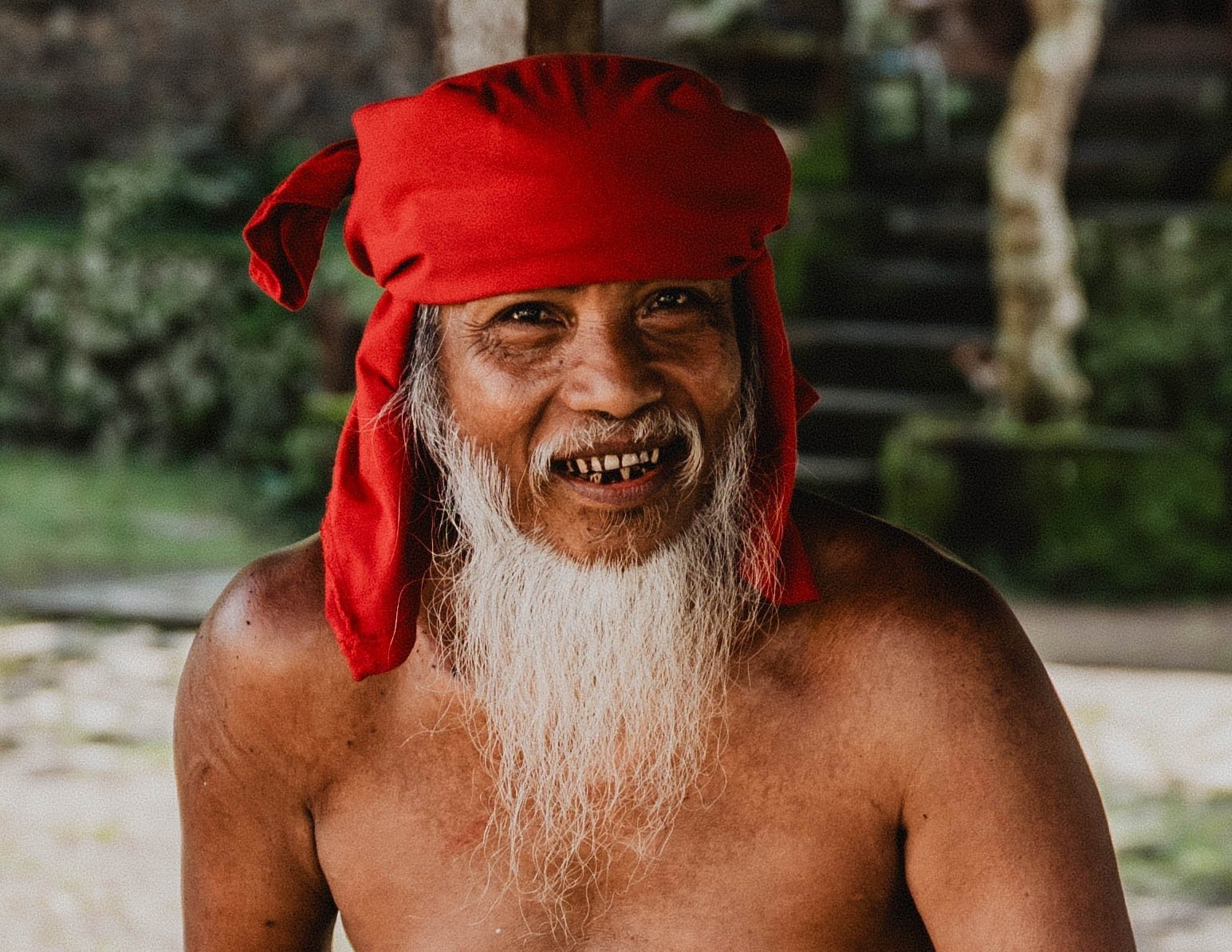 Portrait of an elder in a red headband and white beard in Bali