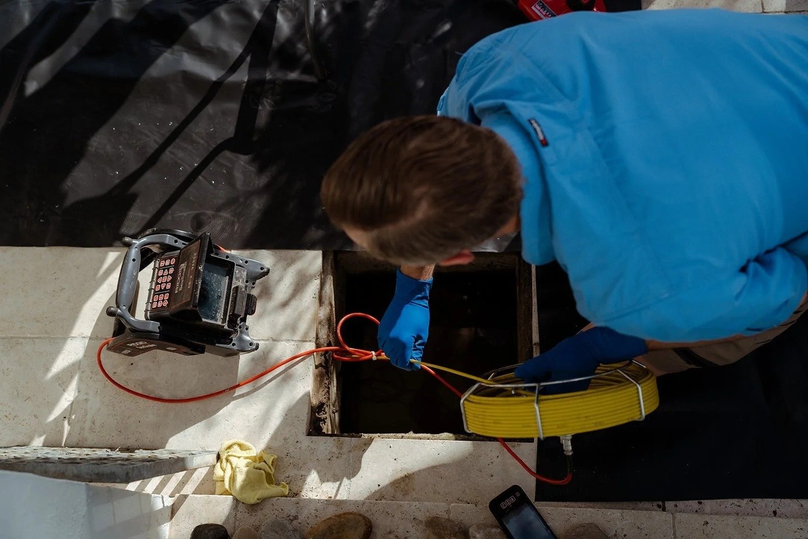 A Thoroughgood Plumbing plumber at work on a job, Central Coast