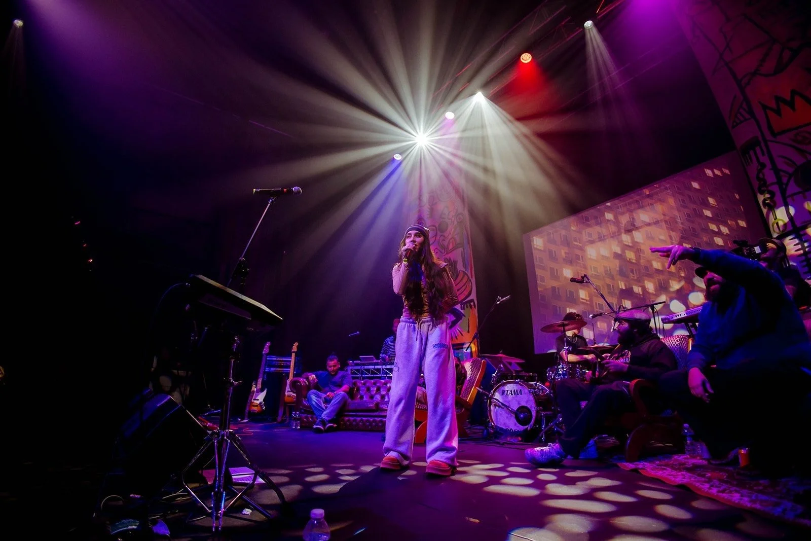 A rapper performing under stage lights at Echoes of the Block, Carriageworks