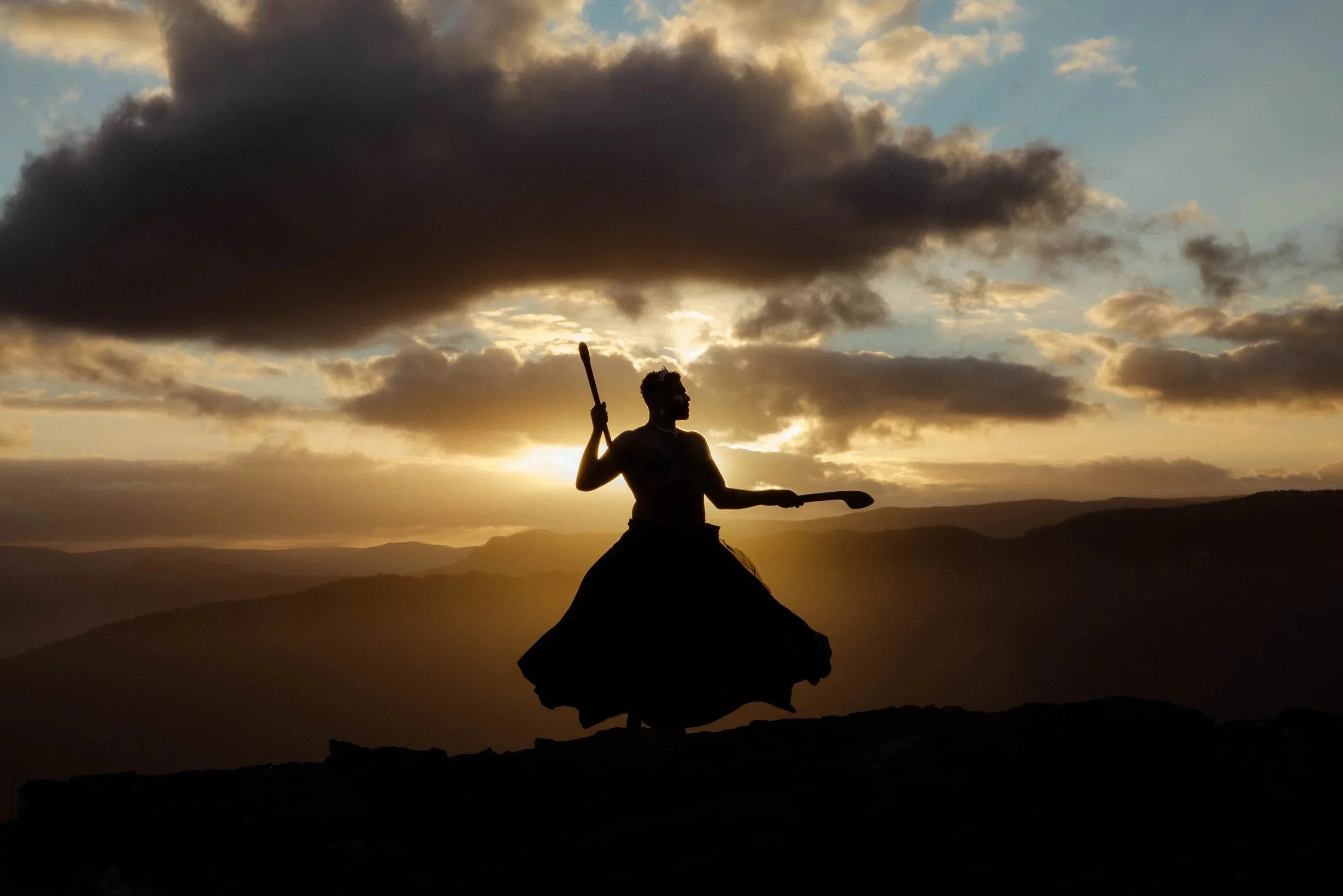 Shaede silhouetted against a sunset on a ridge. The Shaede Project, 2025