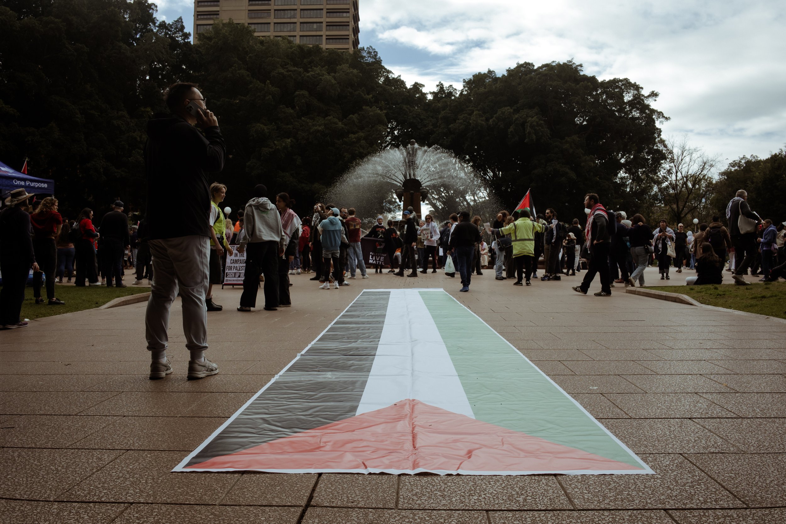 A Palestinian flag painted on the ground, leading toward the Archibald Fountain in Hyde Park