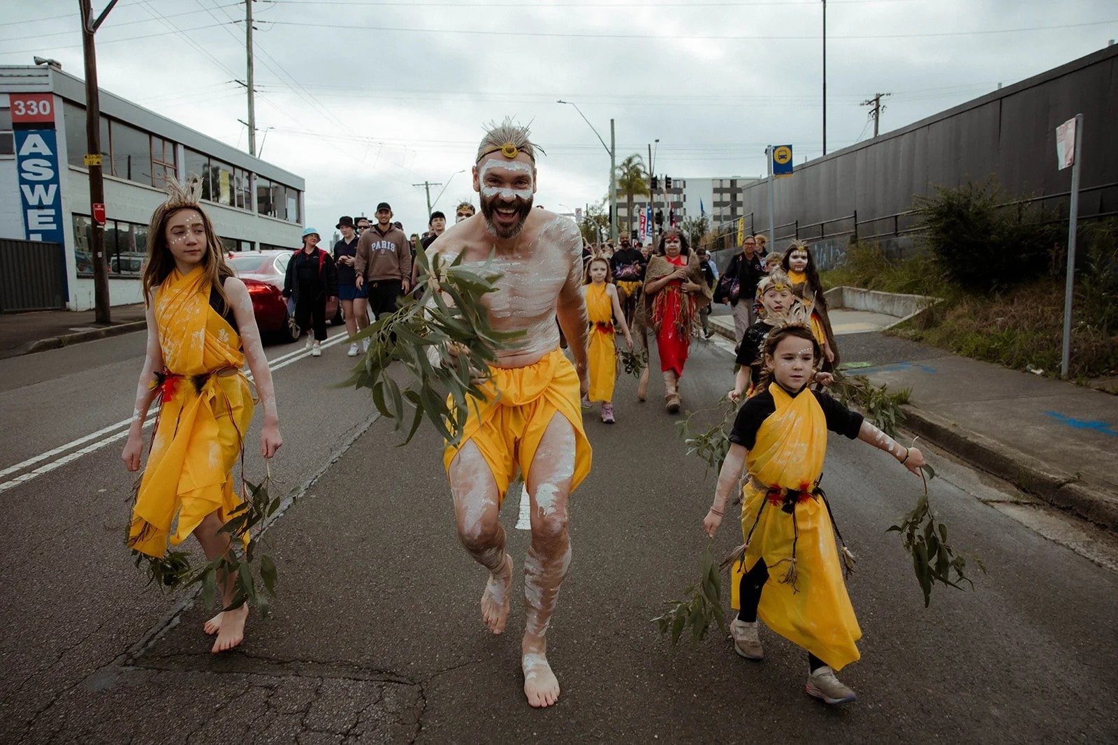 Dancers in ochre leading the Reconciliation Walk through Gosford