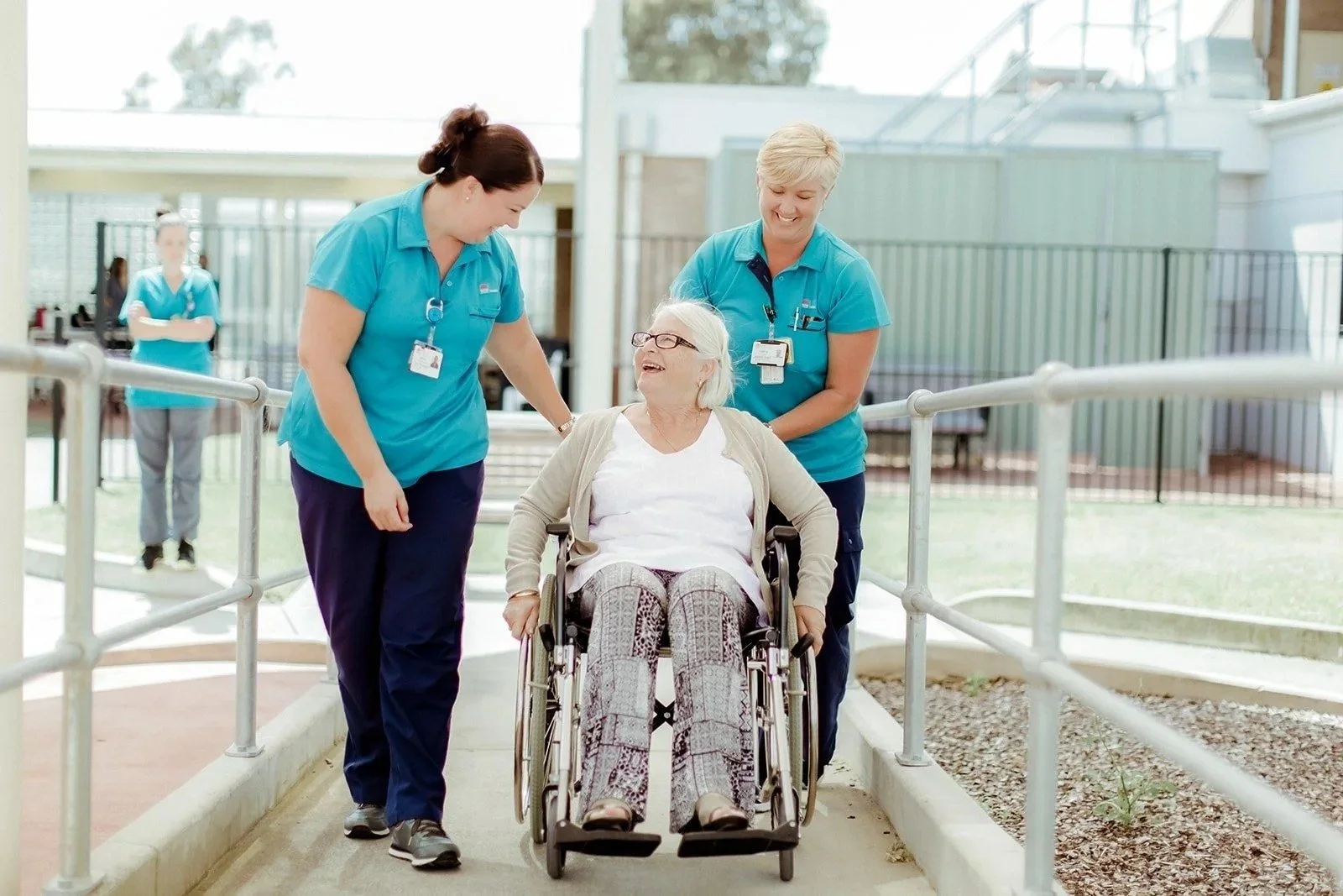 Two nurses with a patient in a wheelchair at Wyong Hospital