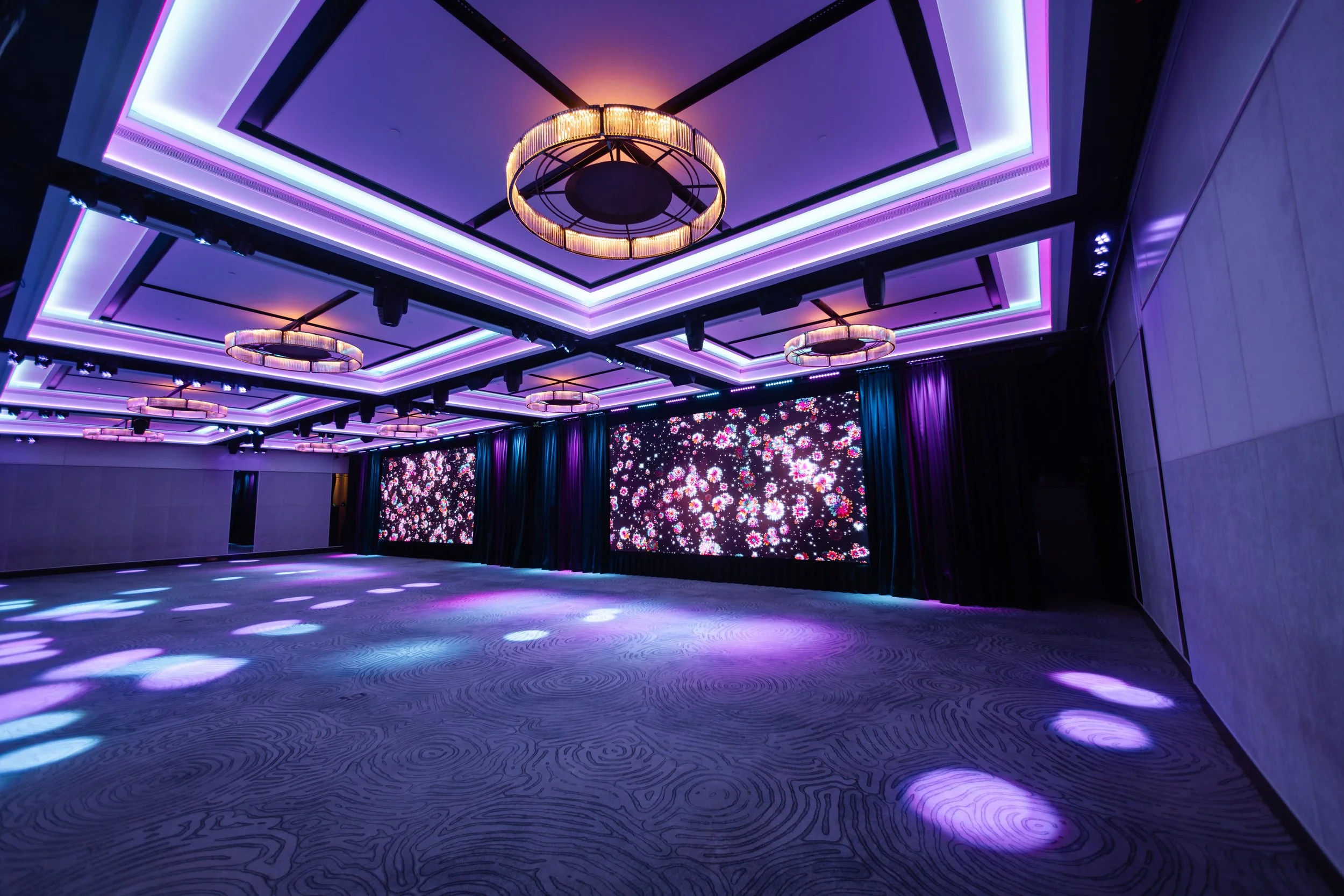 The Grand Ballroom at Four Seasons Hotel Sydney with the LED screen split in two and coloured effects lighting on the floor