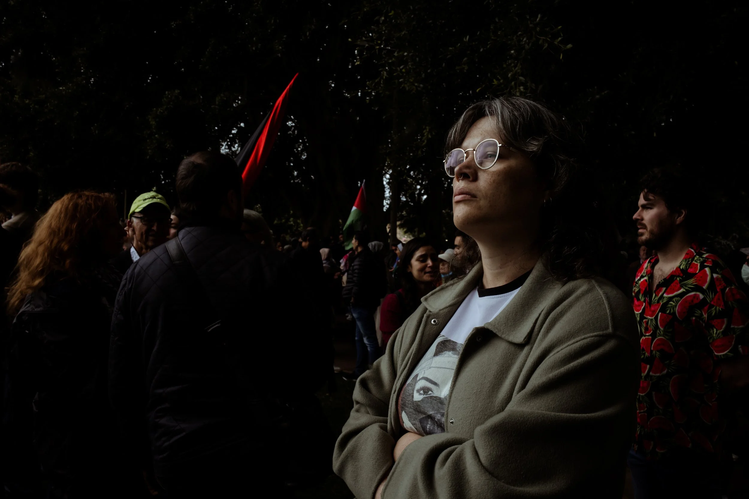 A woman looking up in soft light within the crowd