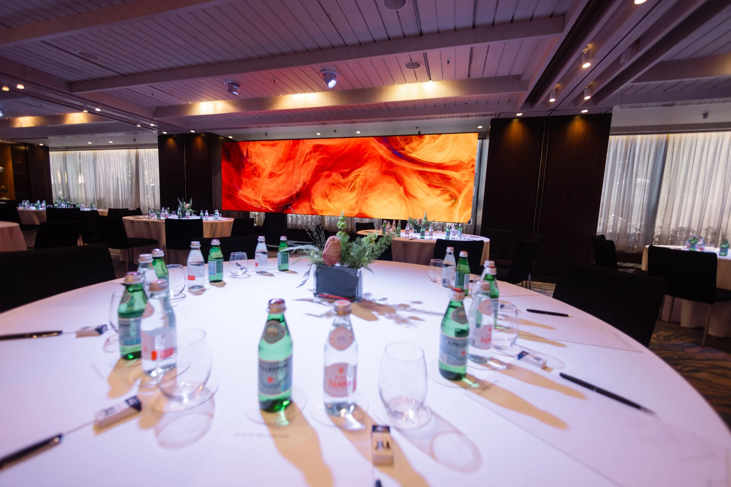 The combined Studio at Four Seasons Hotel Sydney, set for dinner with a screen on the wall