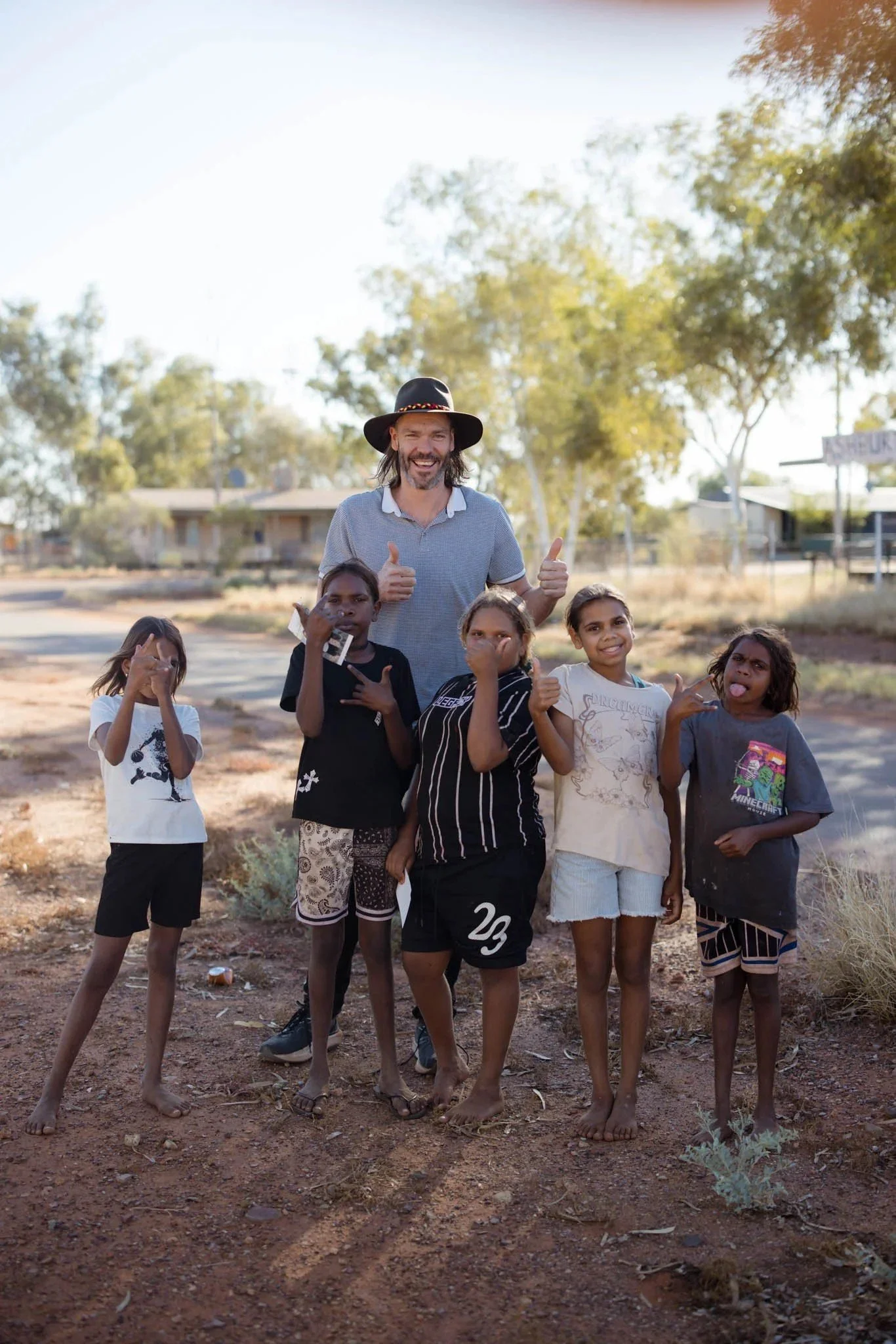 Luke Gemmill with children in Jigalong