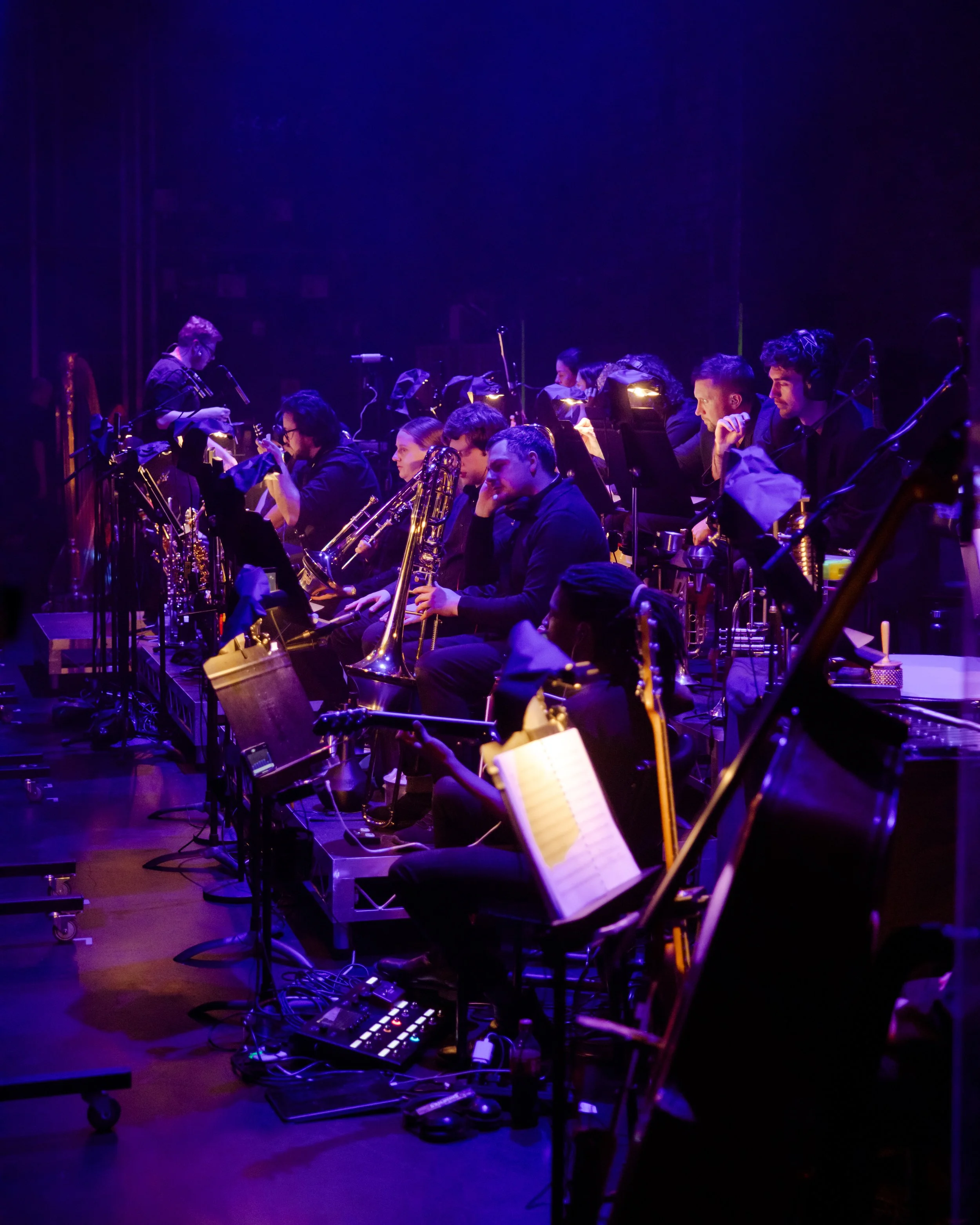 The orchestra pit under purple light during A Chorus Line