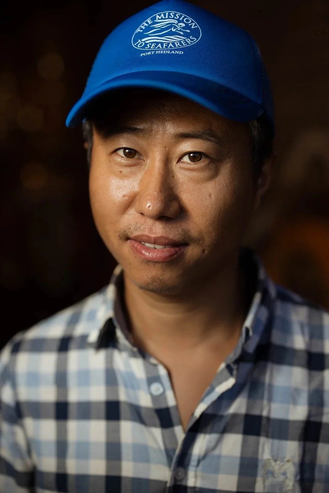 Portrait of a visiting seafarer in a checked shirt and blue cap at the Port Hedland Seafarers Centre