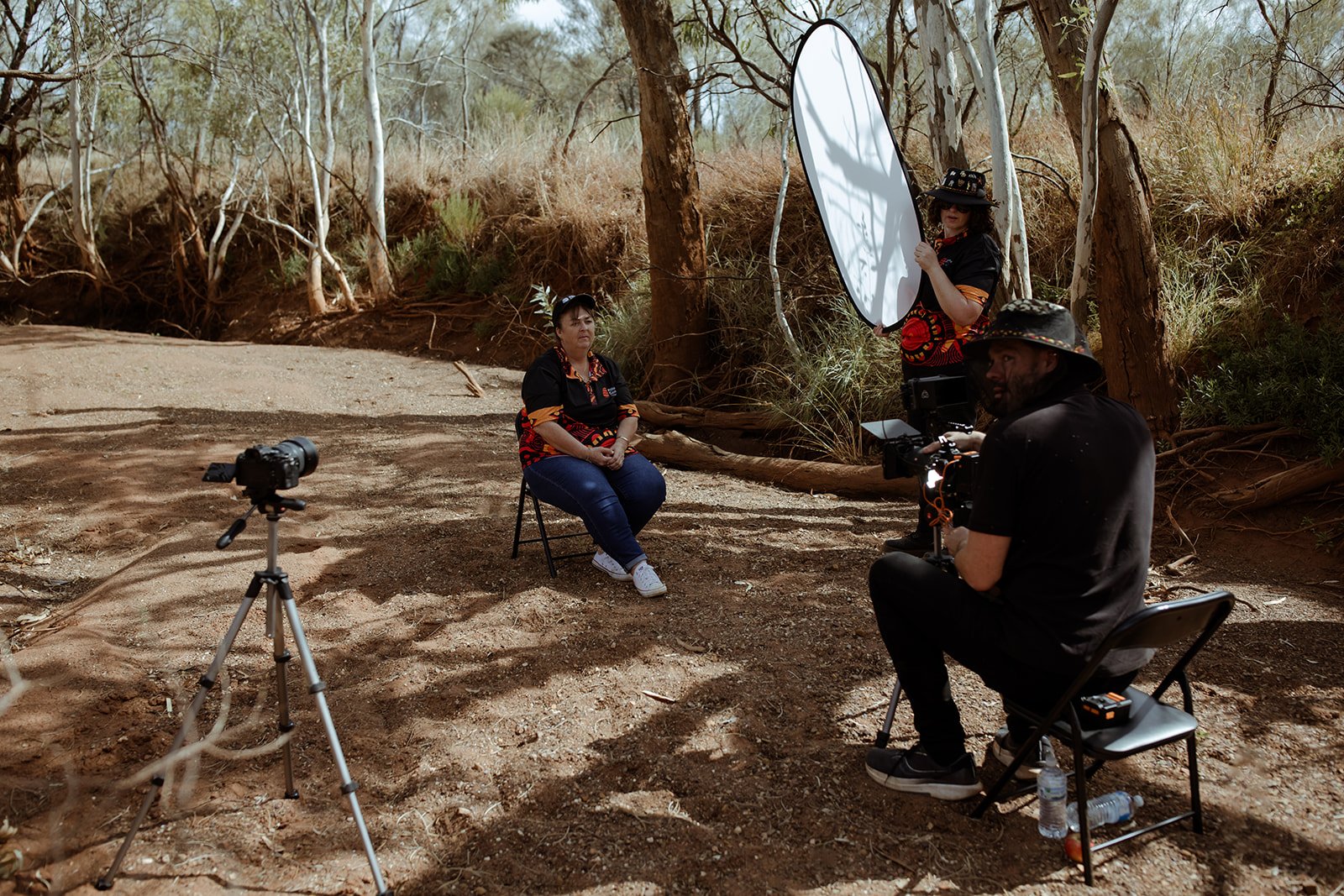 Setting up an interview in a creek bed in Jigalong, with a reflector and two cameras