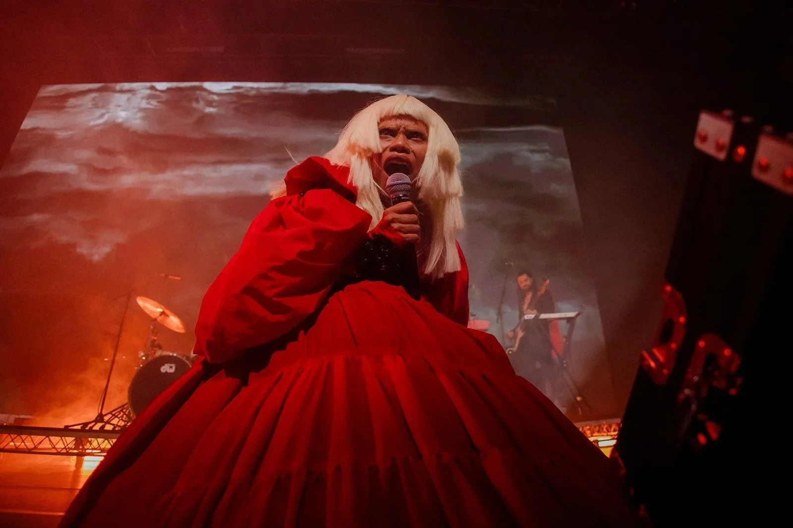 Ngaiire singing in a red gown during PAIA at Carriageworks