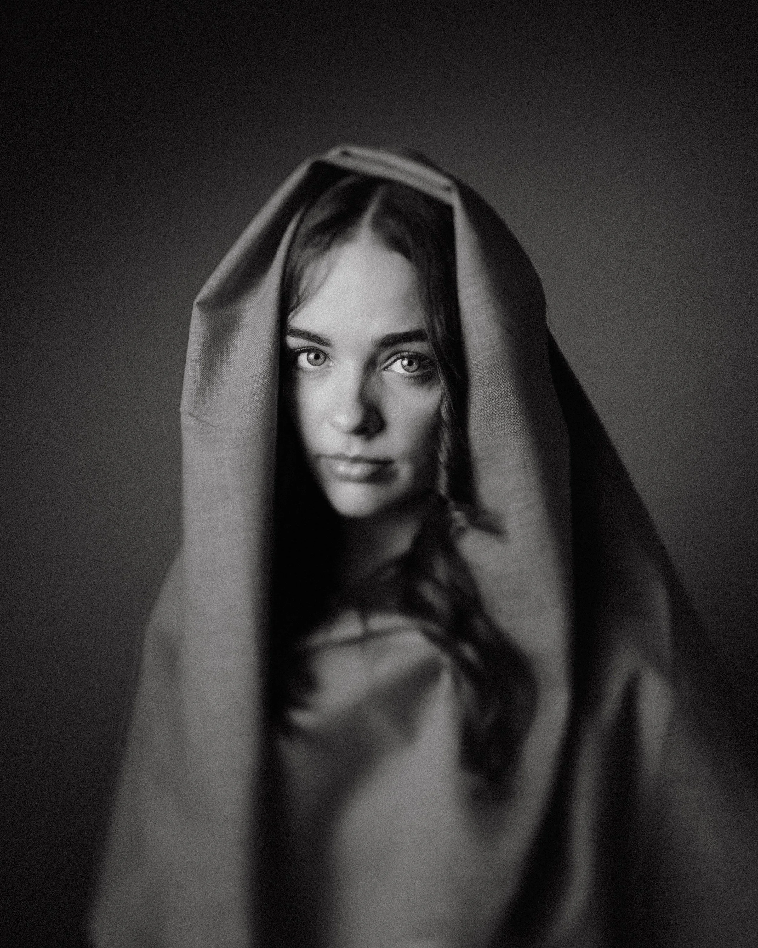 Black and white portrait of Erin Hobden, the hood framing her face