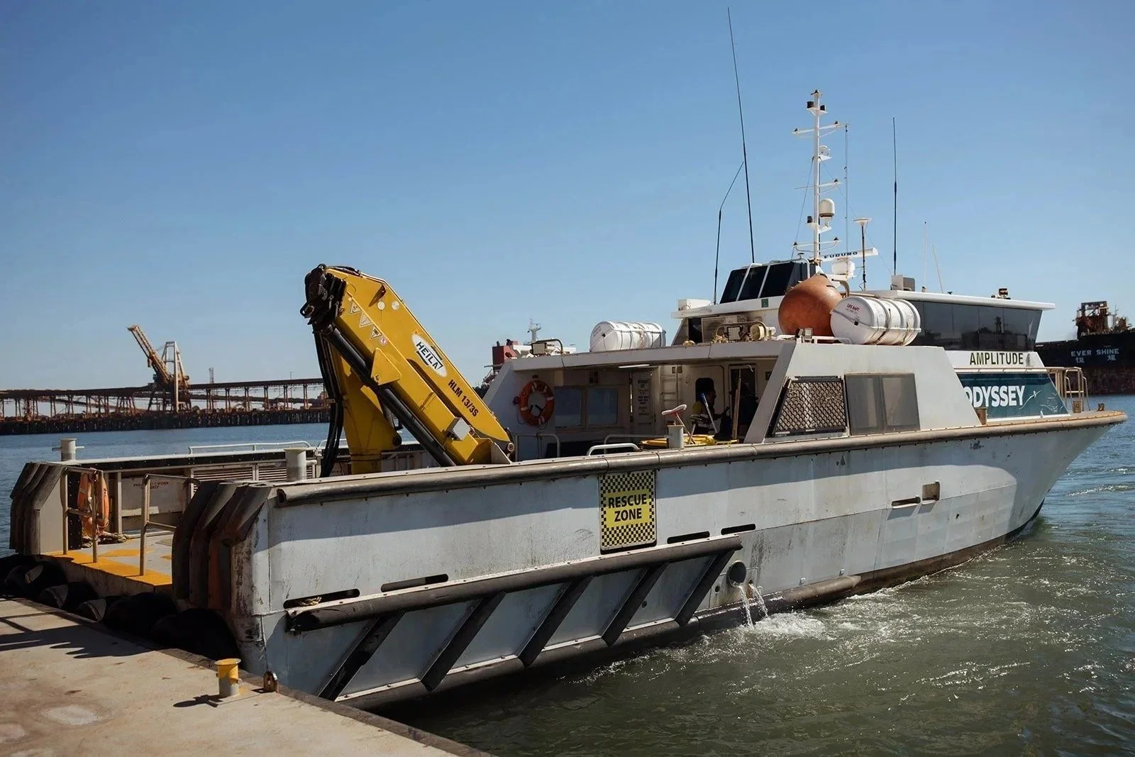A pilot boat beside a bulk carrier in Port Hedland