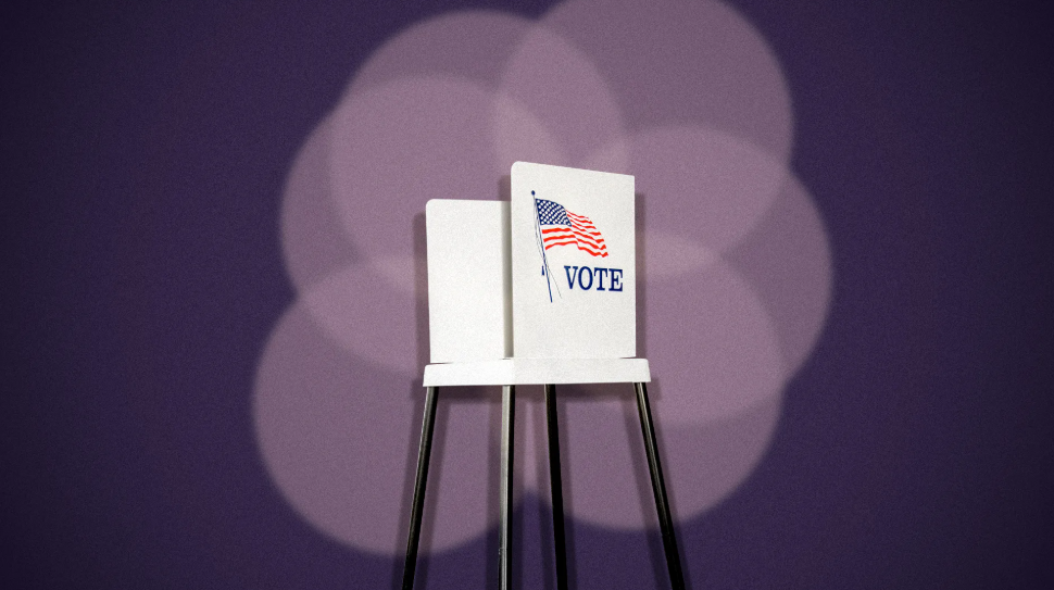 Elections voting booth with American flag and the word 'VOTE' on the front, set against a purple background.