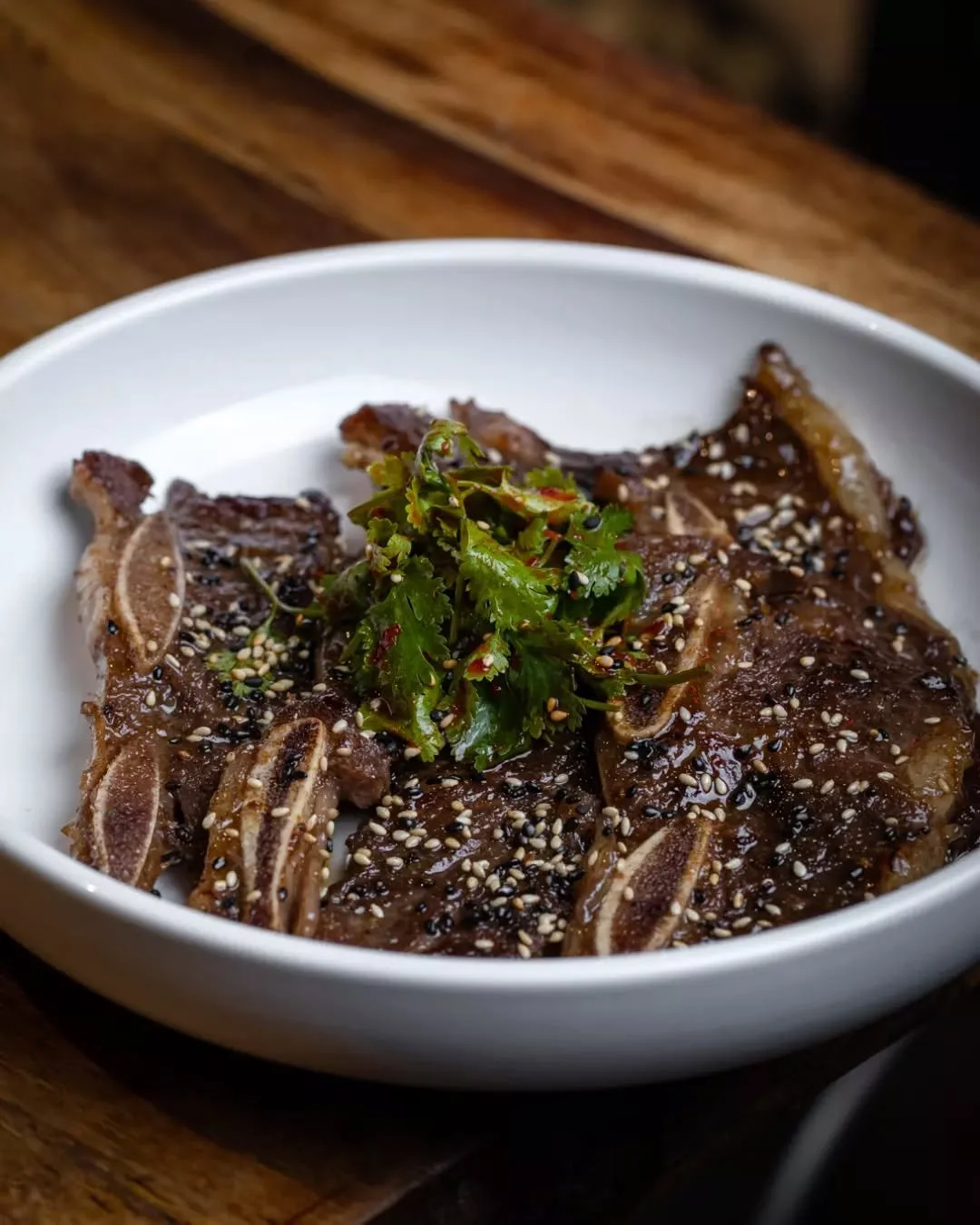 Our L.A. Galbi &mdash; galbi-sauce glazed short ribs with coriander muchim &mdash; is best eaten the Korean way: grab it with your hands and bite straight in. Messy? Maybe. Worth it? Absolutely.