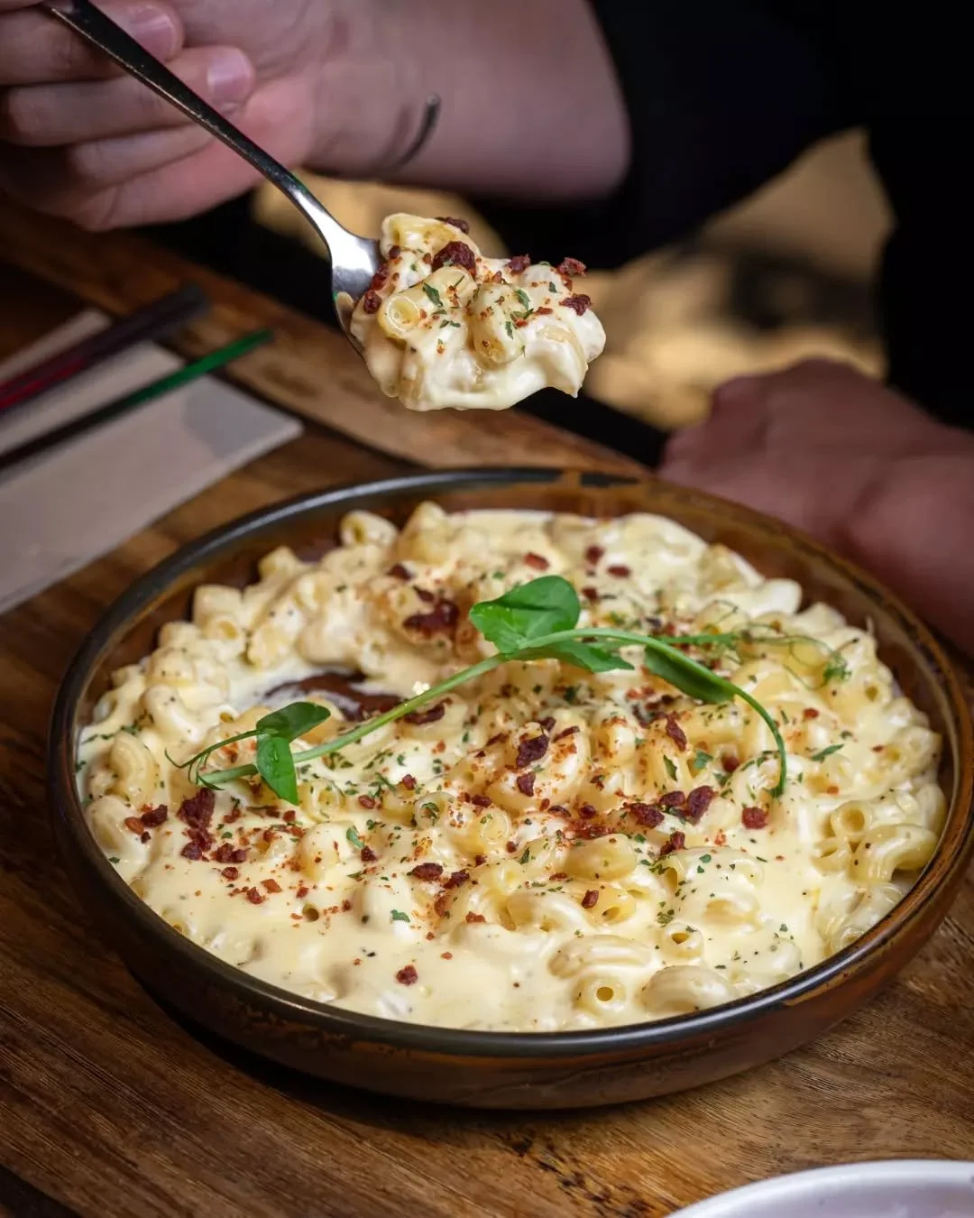 Our Mac &amp; Cheese. Creamy cheese sauce, tender pasta, and a golden topping of bacon crumbs. Classic, creamy and cosy.