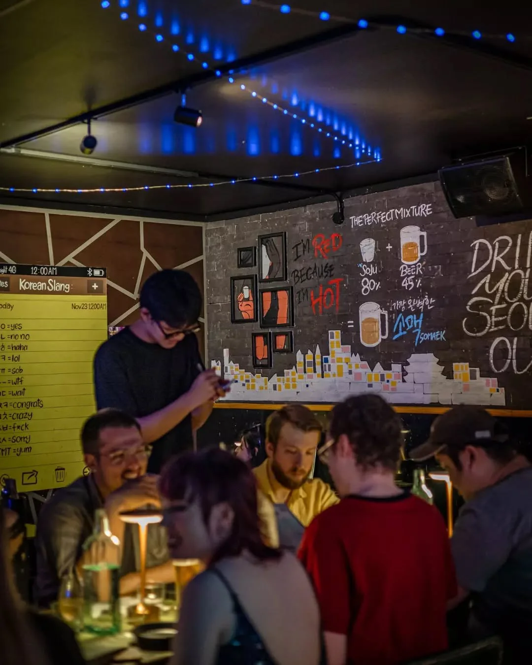 Tables full conversations loud glasses clinking. The kind of night that only happens at Seoul Night.