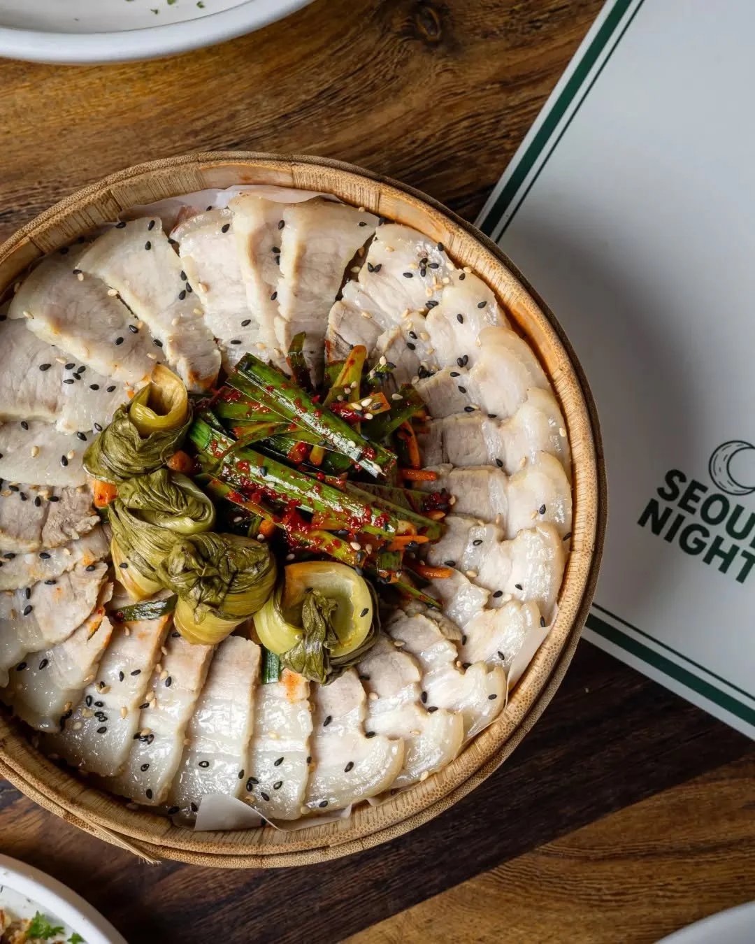 Bossam done the Seoul Night way ✨ Slow cooked pork belly served tender and rich, paired with Korean style chive muchim made with fresh garlicky chives tossed in soy, sesame and chilli and bright pickled bok choy.