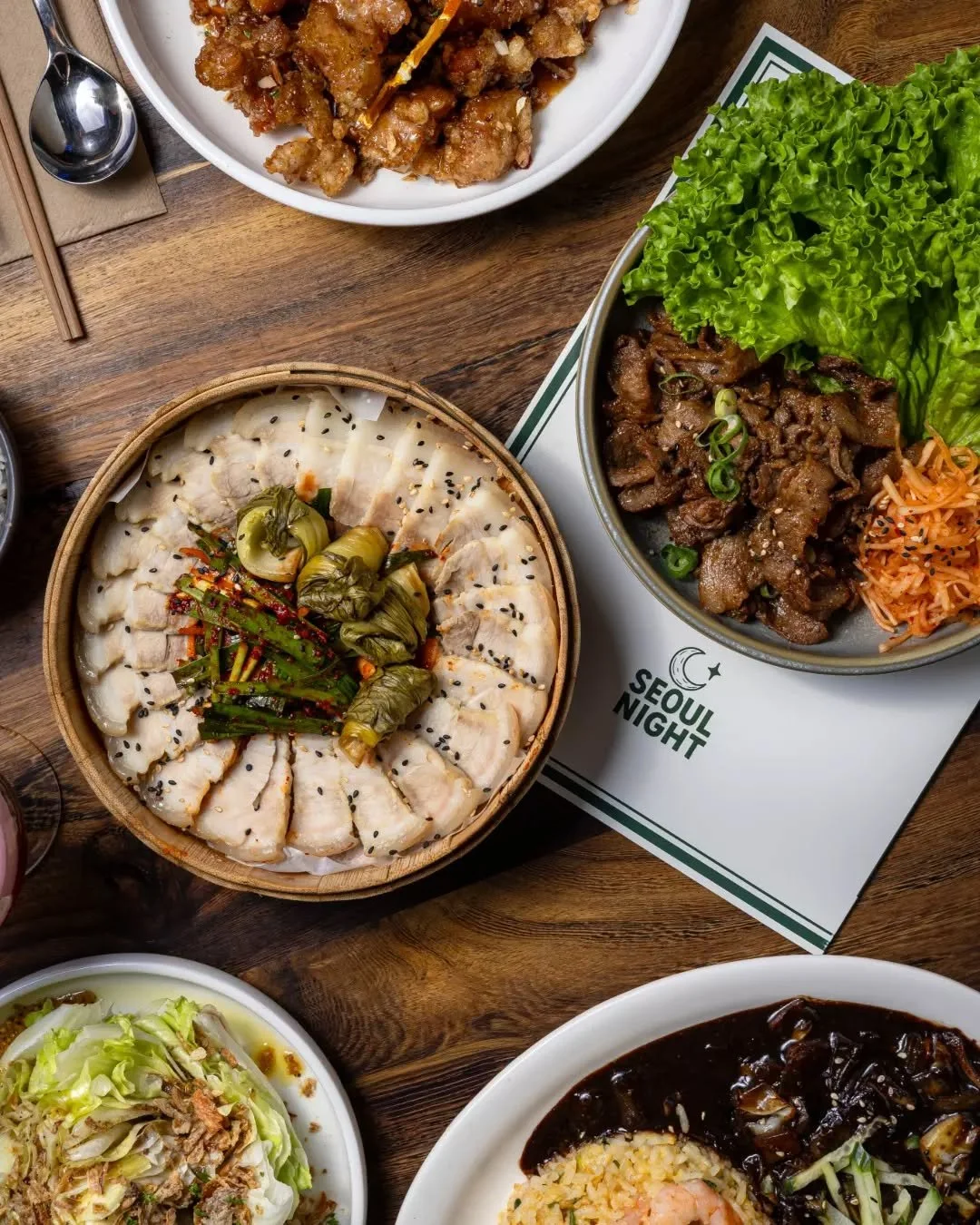 Which corner of the table are you reaching for first? 🤔🥢

1. Bossam: Succulent pork belly made for wrapping. 
2. Jajangmyeon Fried Rice: A smoky, comforting twist on a classic. 
3. Honey Soy Chicken: Perfectly glazed, sweet, and salty. 
4. Sherry W