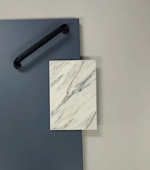 This pairing works because each element brings something different to the overall look.

The countertop adds movement and variation, which keeps the design from feeling flat, while the subtle tones in the slab help tie back to the cabinetry color. Ag