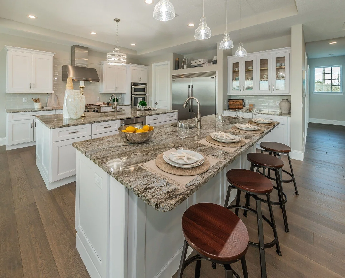 This kitchen works well because the layout adds function along with visual impact.

The two bar setup creates separate zones for seating, prep, and entertaining, which helps the space work better when multiple people are using it. On the right, the i