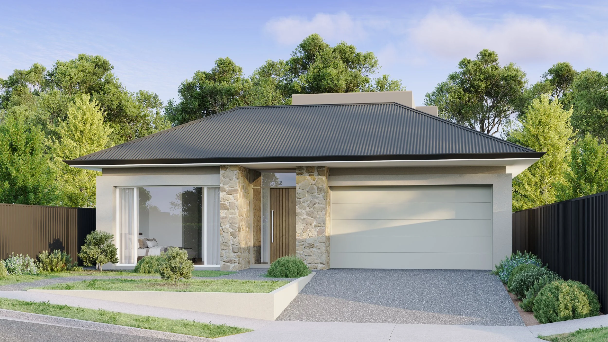 Modern house with stone accents, large glass windows, grey metal roof, black fencing, landscaped yard with bushes and grass, trees in the background, and a partly cloudy blue sky.