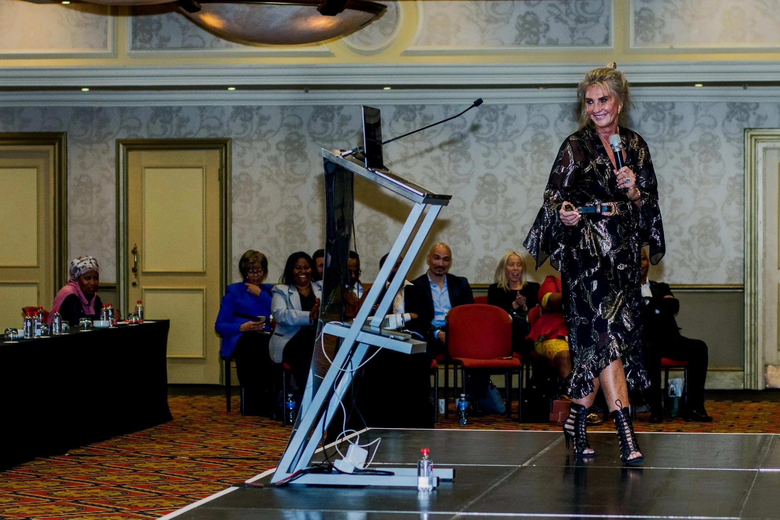 Alison speaking on stage on the topic of branding and identity