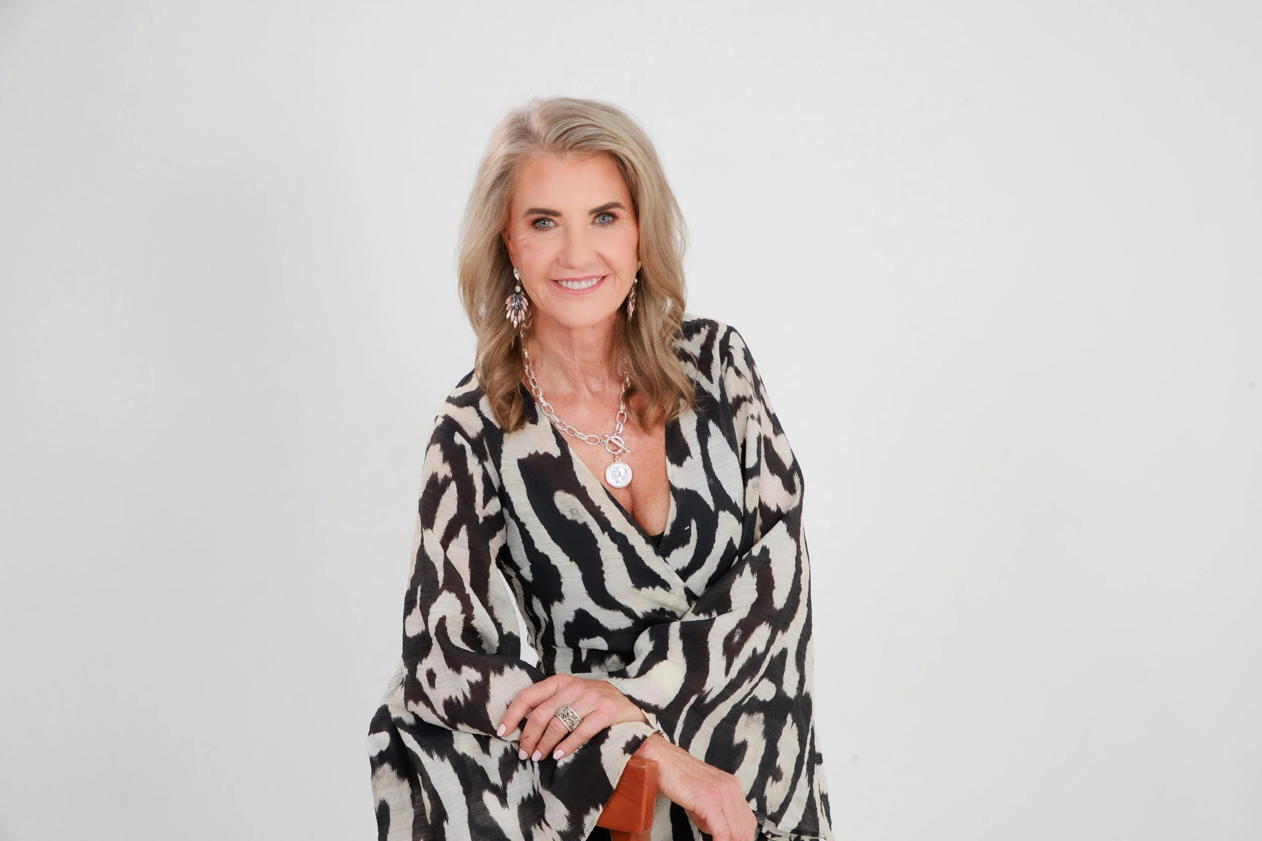Alison Weihe posing in a black and white bell sleave dress