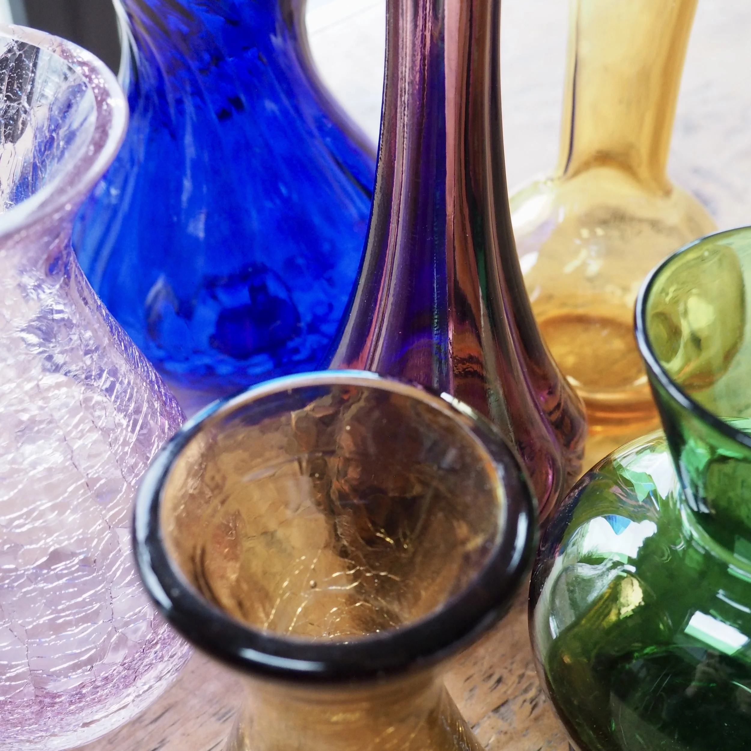 Close up of a collection of colourful art glass vases