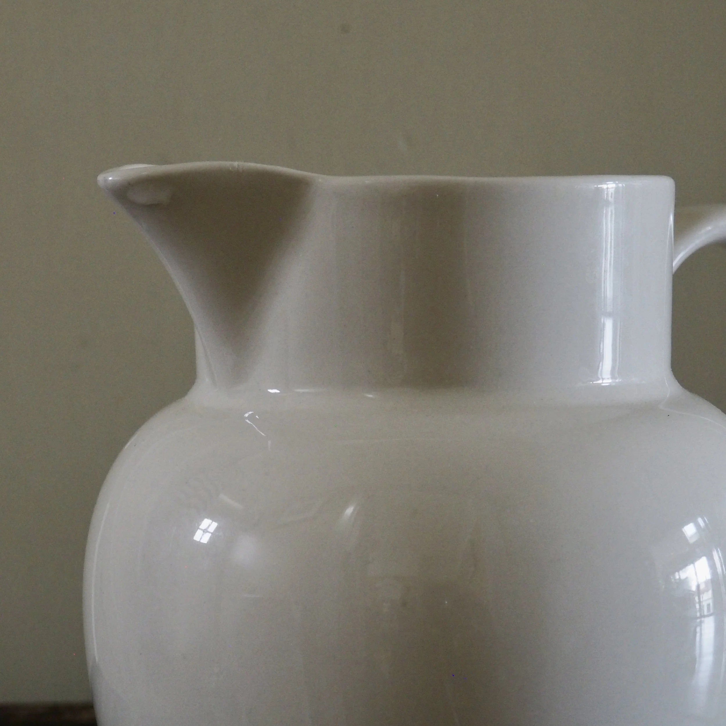 close up of a white vintage milk jug