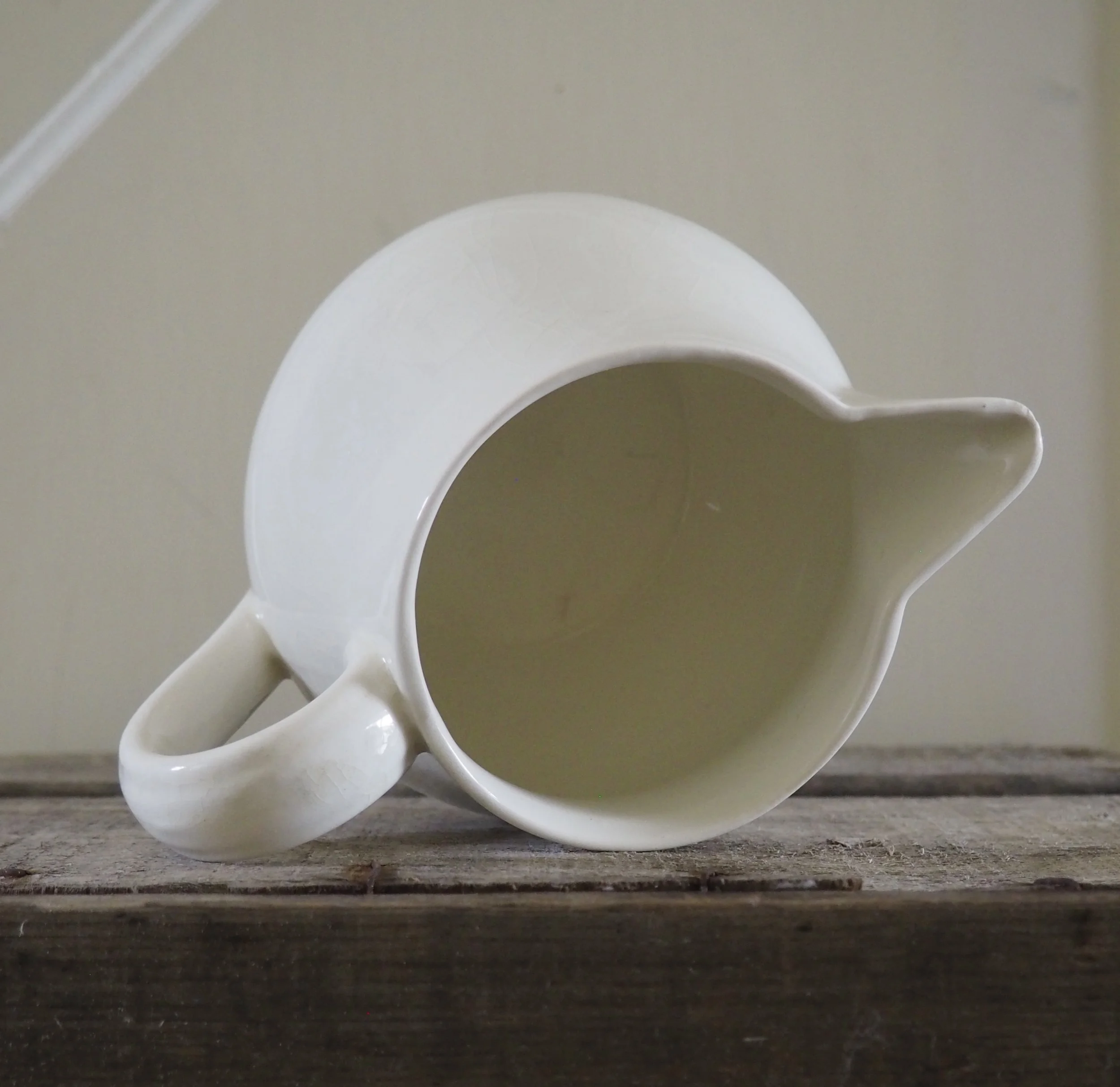 top view of a white jug on its side