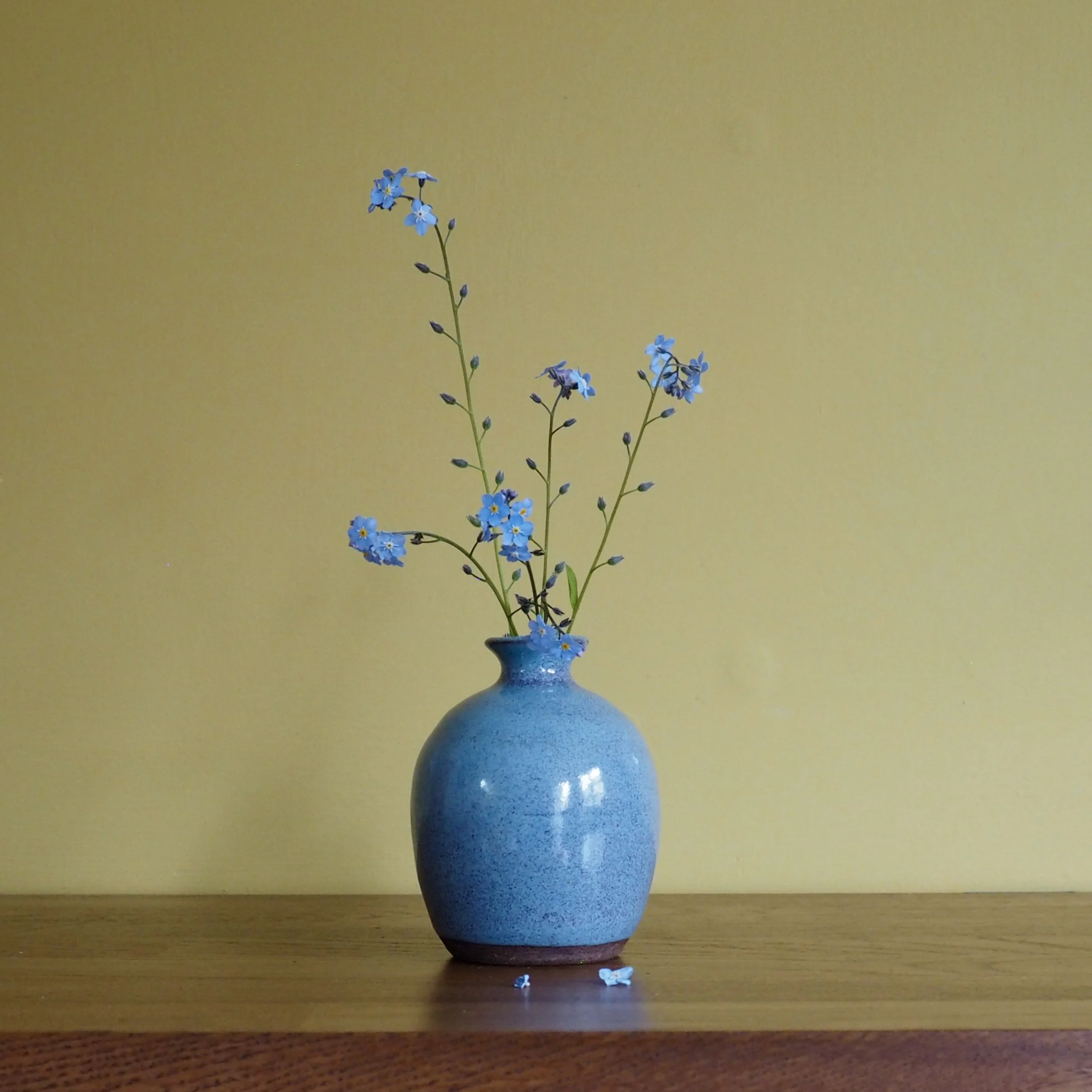 Small blue glazed stem vase