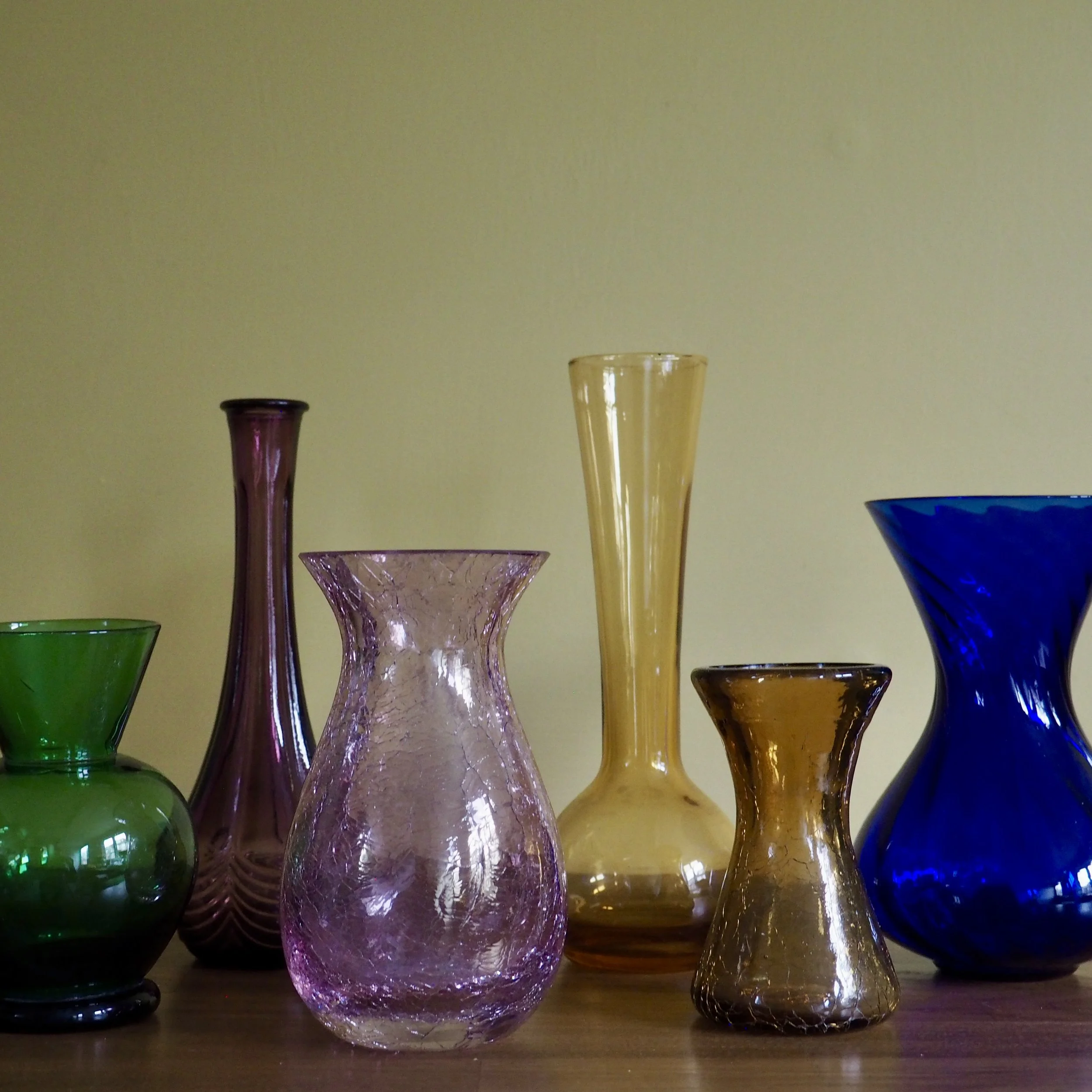 A collection of colourful vintage glass vases