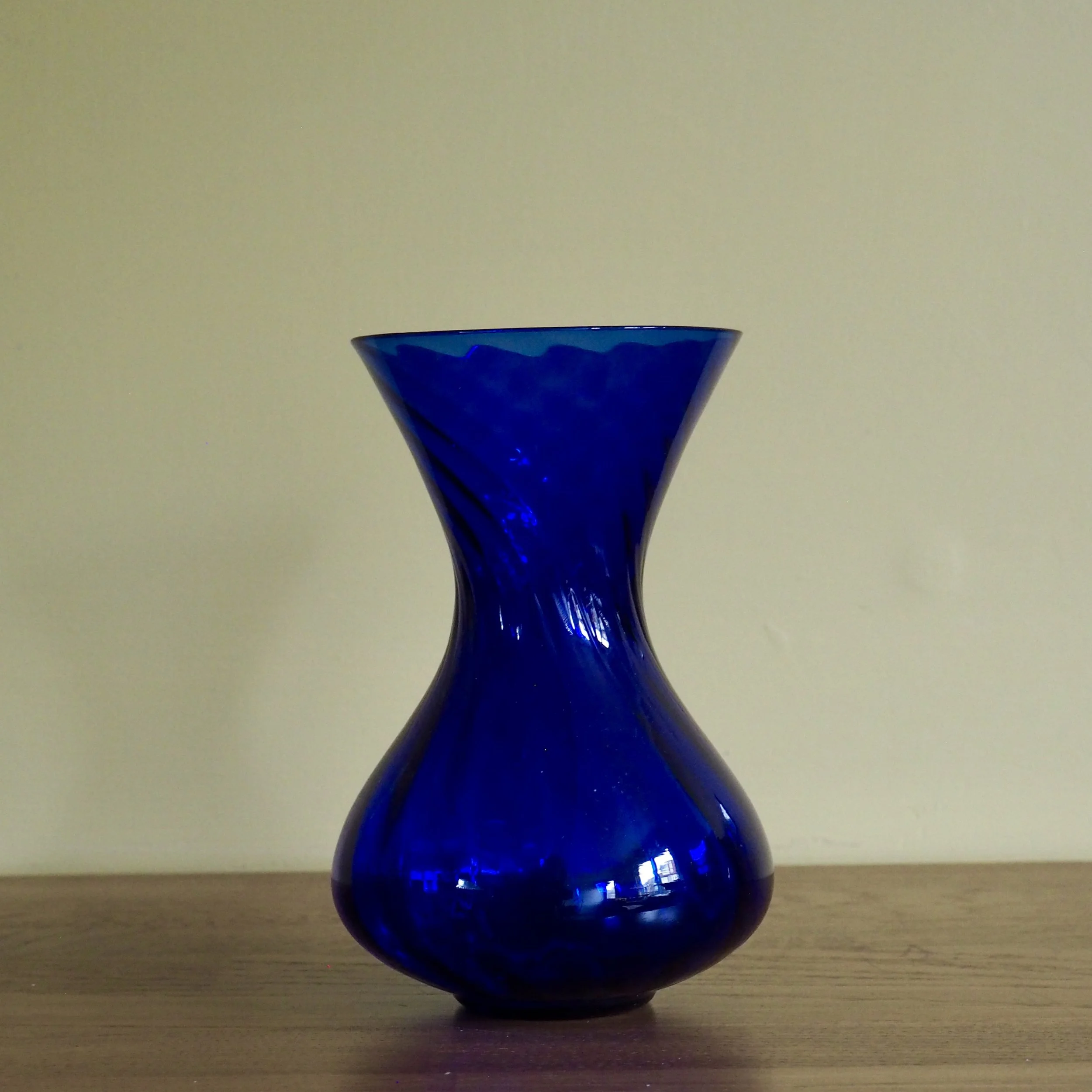 Deep blue vintage art glass vase with a twist pattern detail