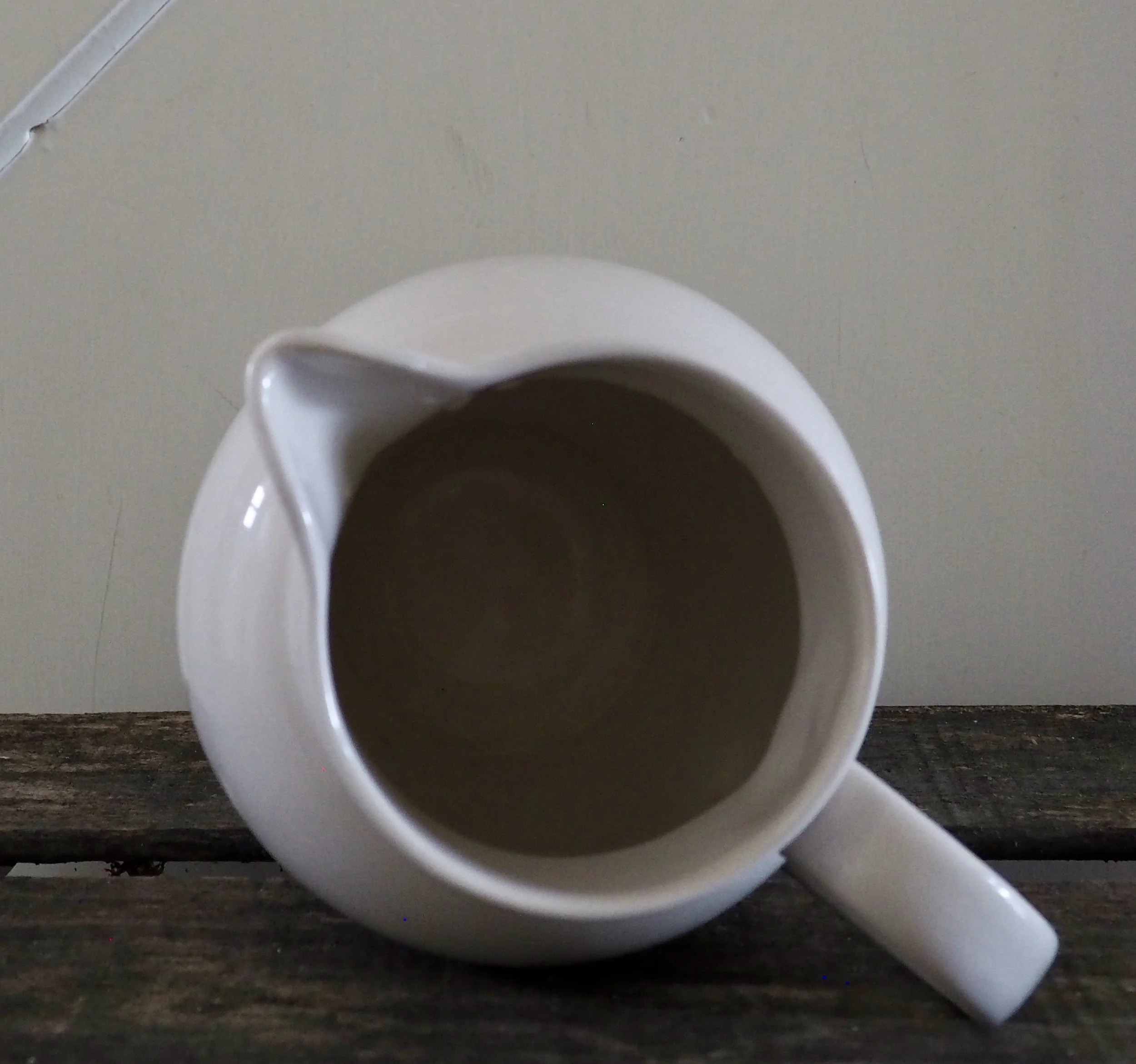 vintage milk jug on its side