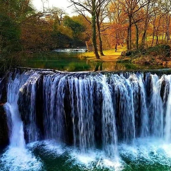 A_cascading_waterfall_plunges_into_a_turquoise_yN893qLN.jpg