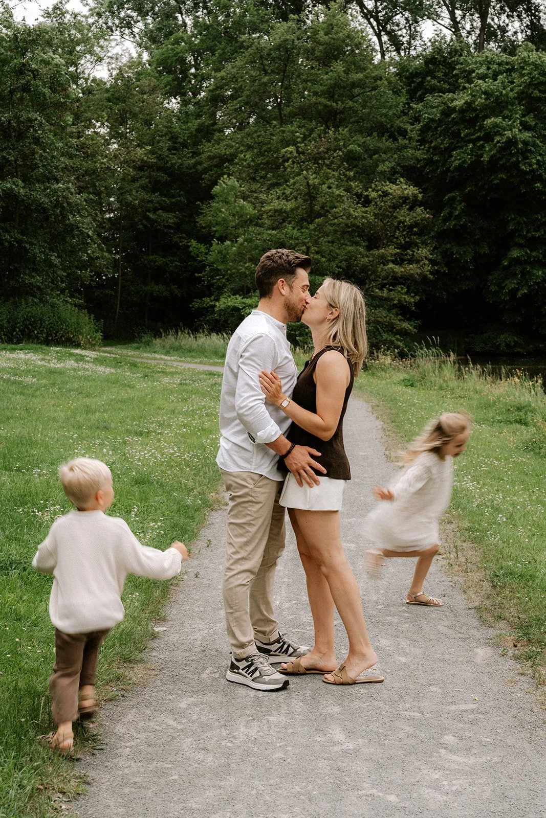 Spelende kinderen en ouders die genieten van dit moment tijdens een leuke fotoshoot in de natuur