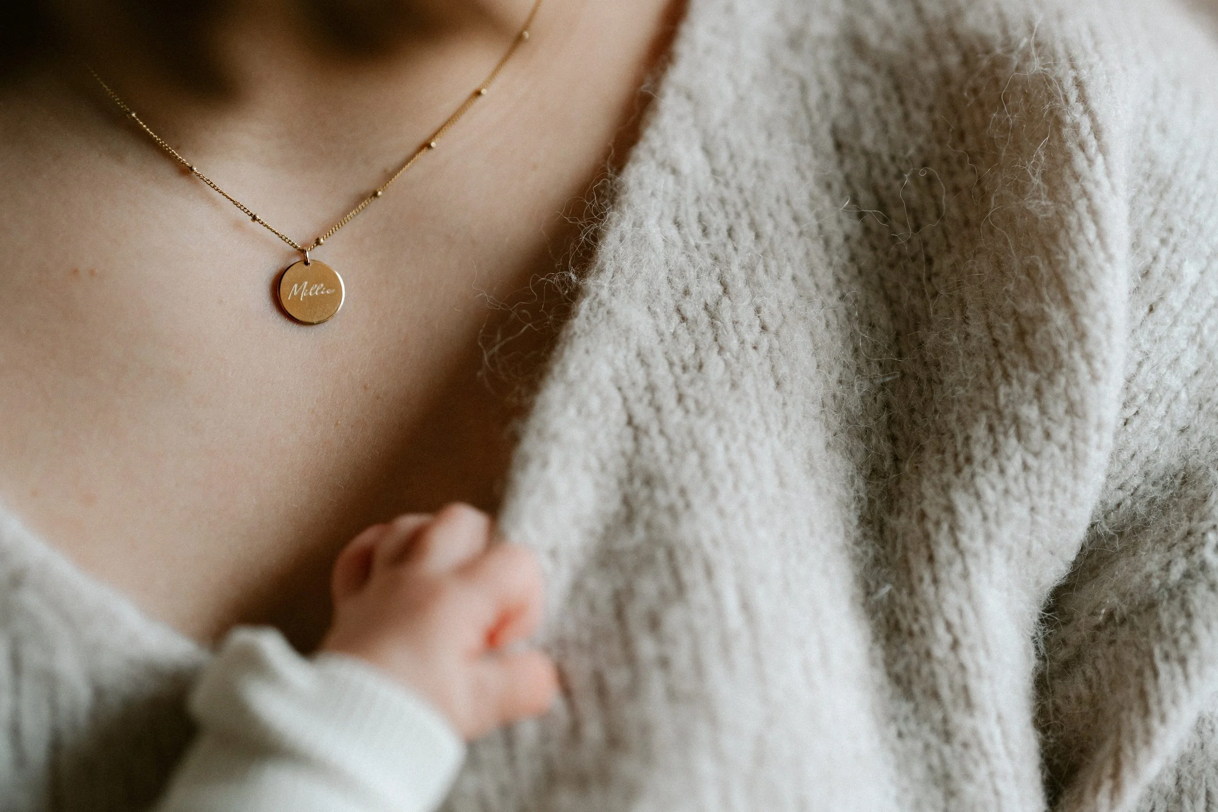 newborn baby captured in soft tones inside the family home
