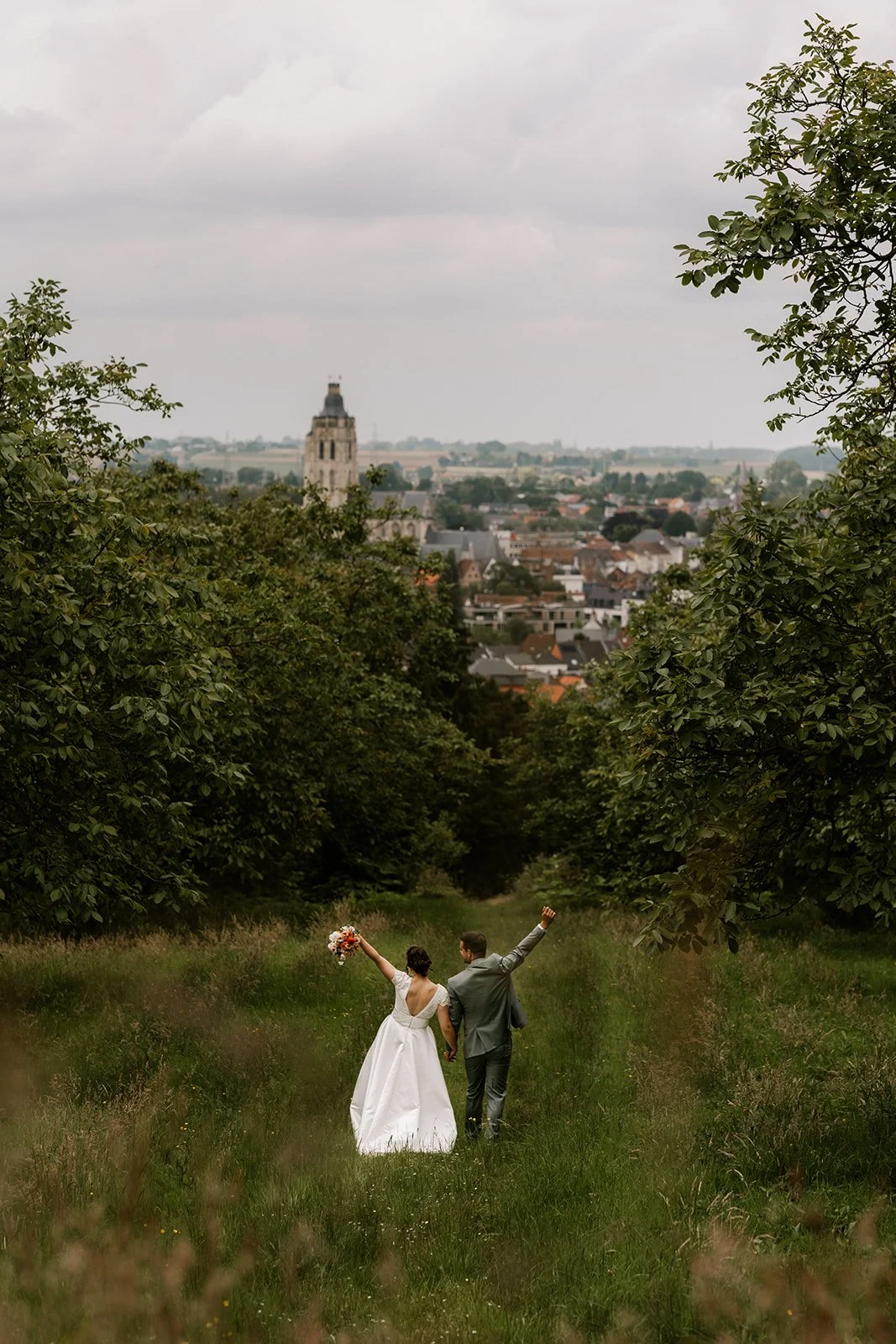 bride and groom walking in nature during intimate couple photoshoot in oudenaarde