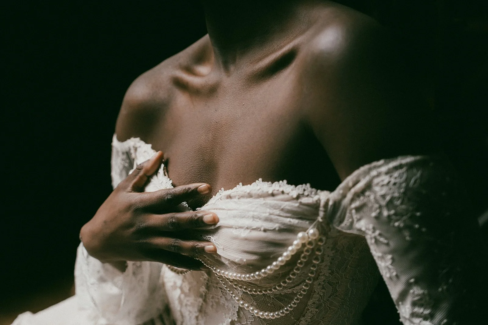 Soft light on black woman during boudoir photoshoot