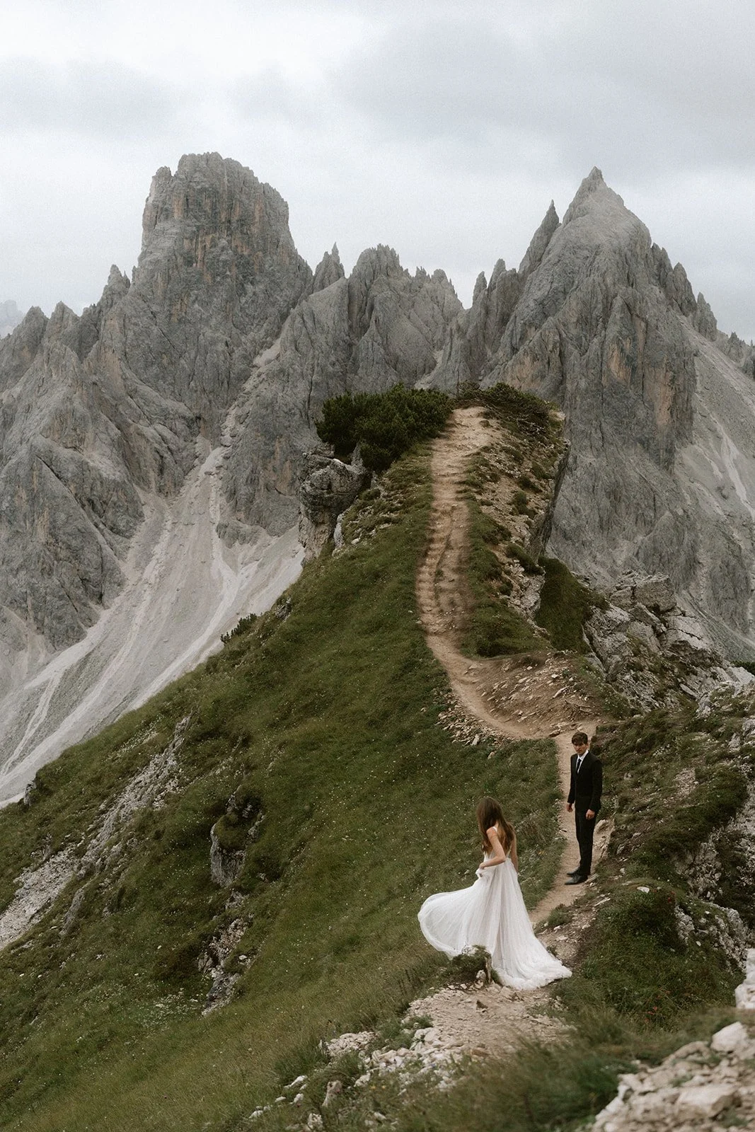 couple walking towards cadini di misurina during elopement in the dolomites