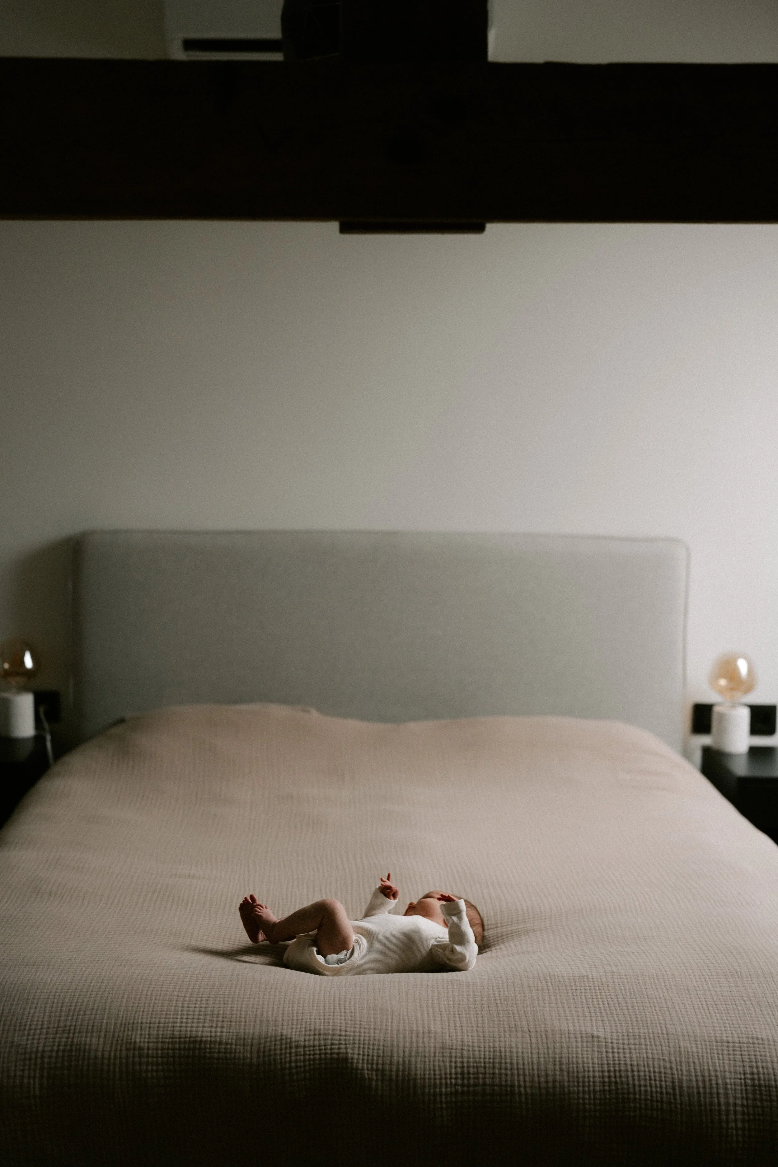 newborn nestled into soft blankets at home