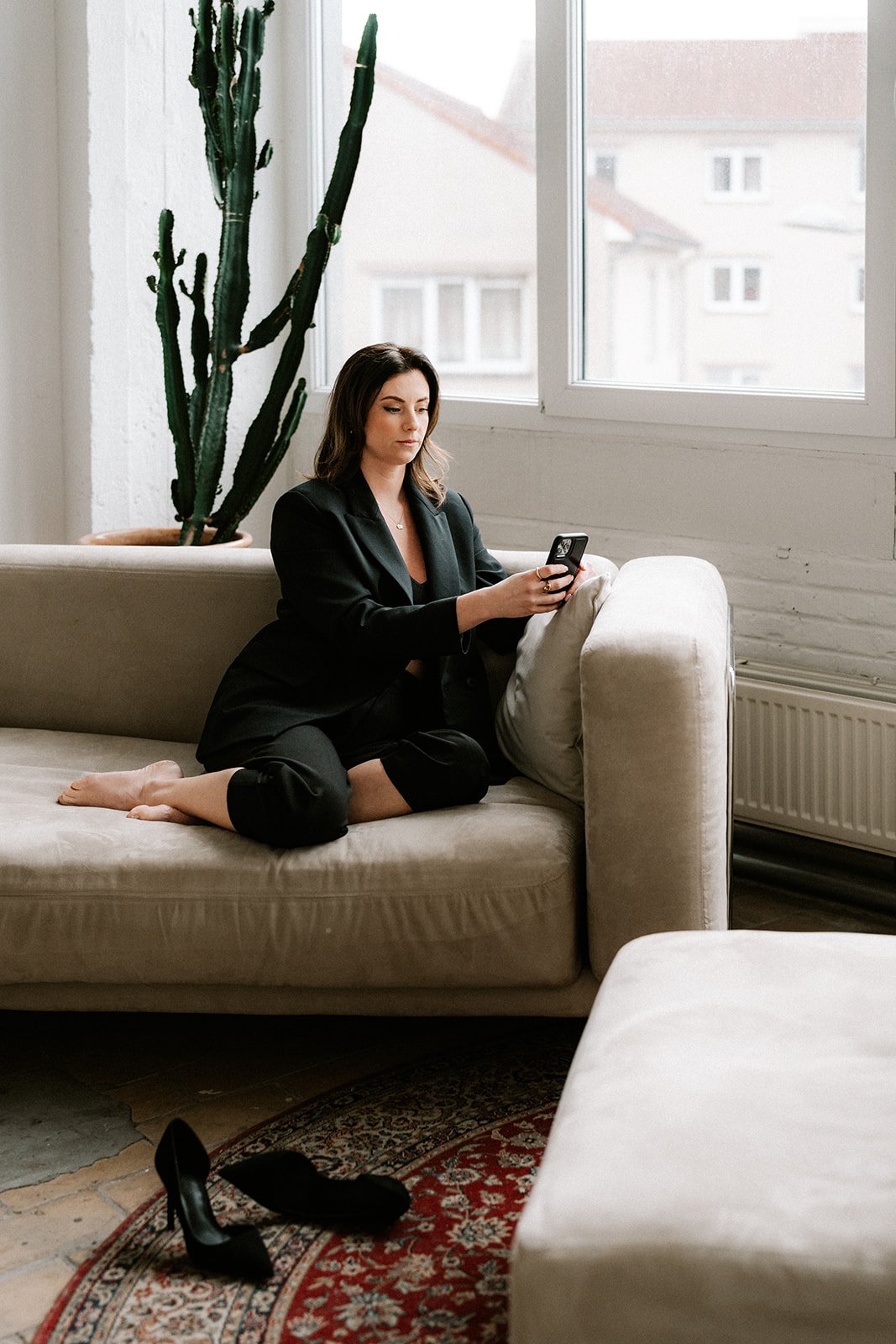 Seated branding portrait in a calm studio environment with soft tones