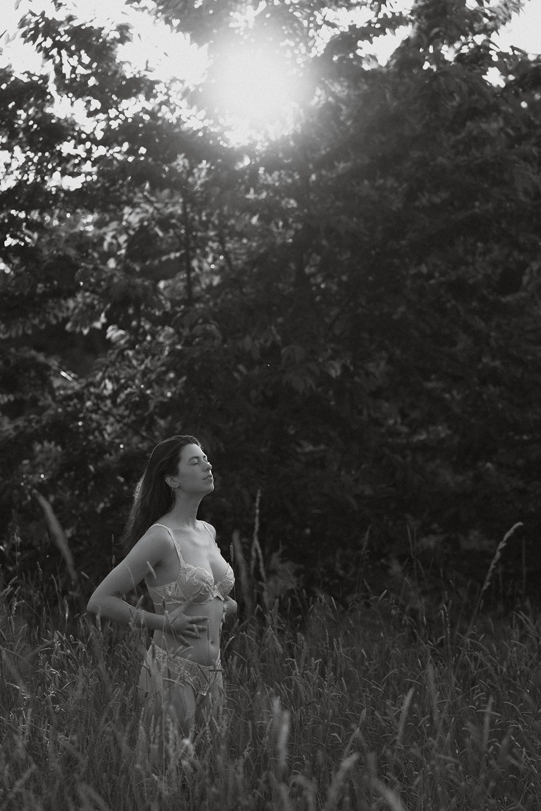 cinematic outdoor boudoir photo of a woman surrounded by greenery, boudoir photography Belgium