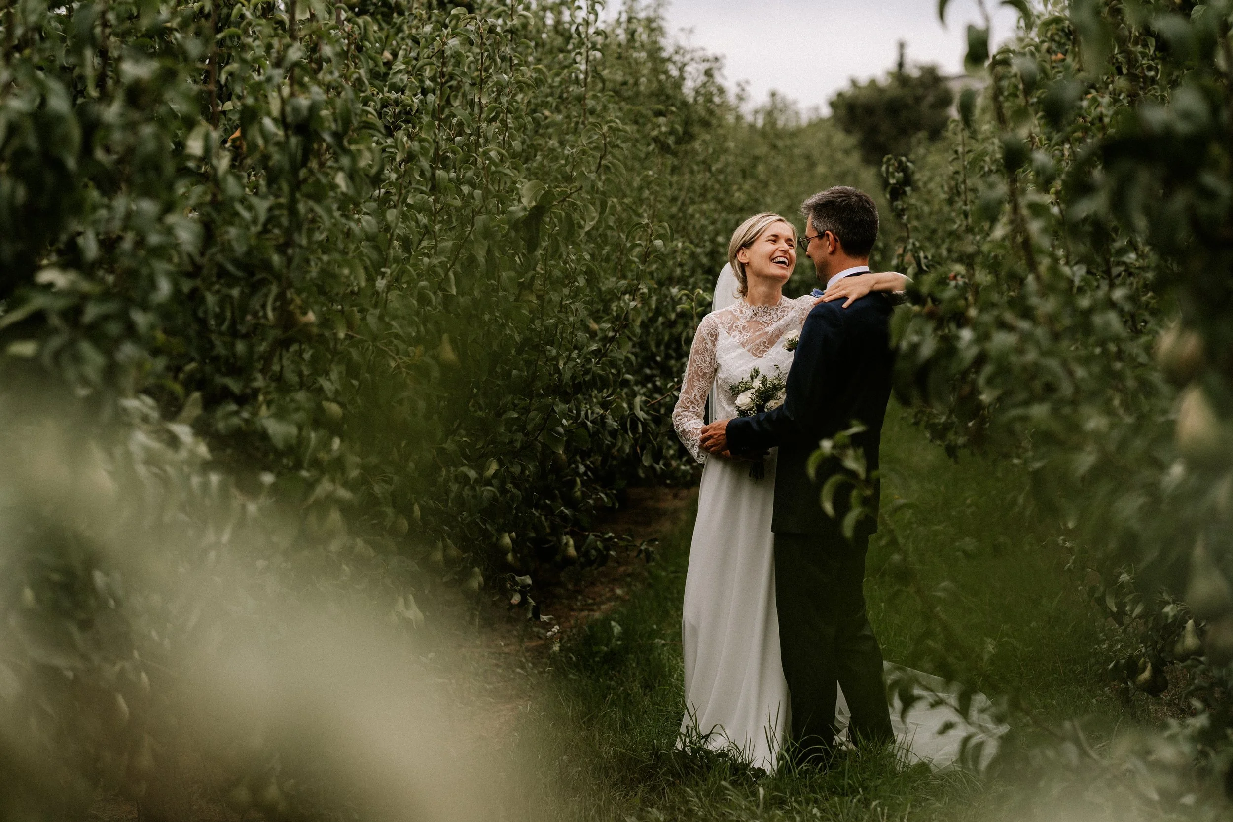 Couple standing in nature during their wedding photoshoot