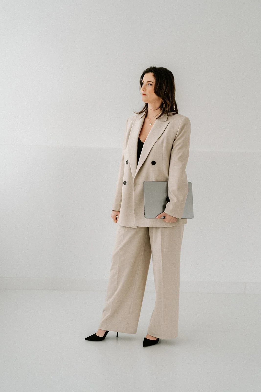 Minimalist branding photoshoot of an entrepreneur in a calm studio setting