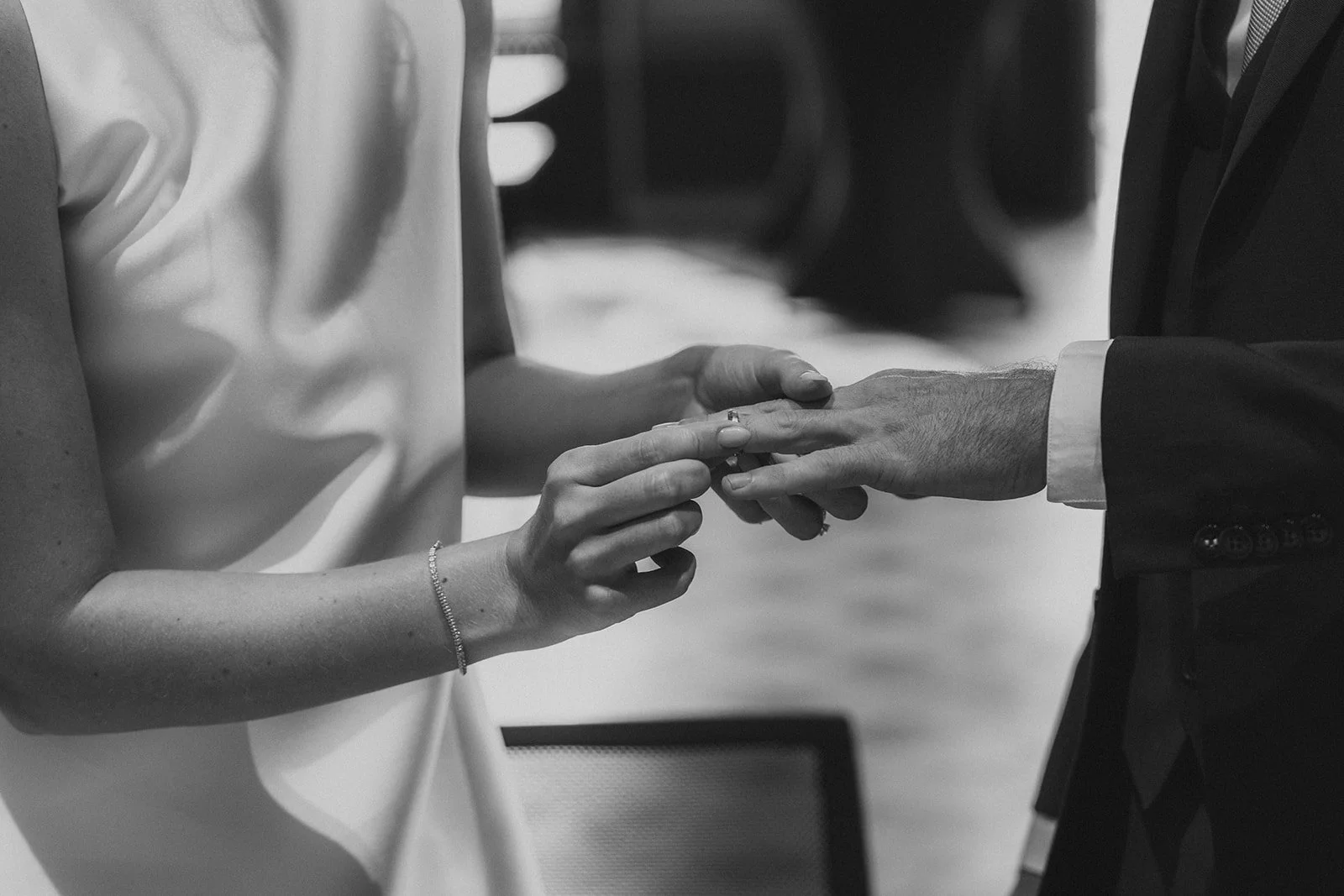 bride and groom exchanging rings during intimate wedding ceremony