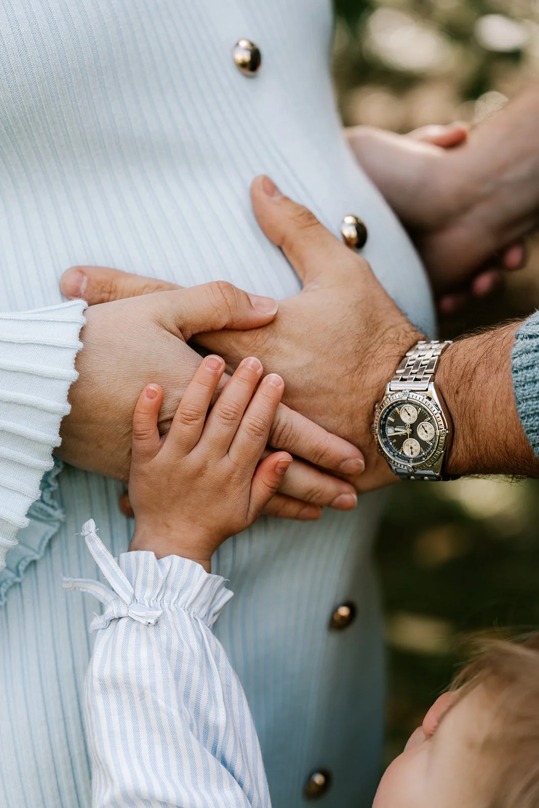 hand holding on a pregnant belly
